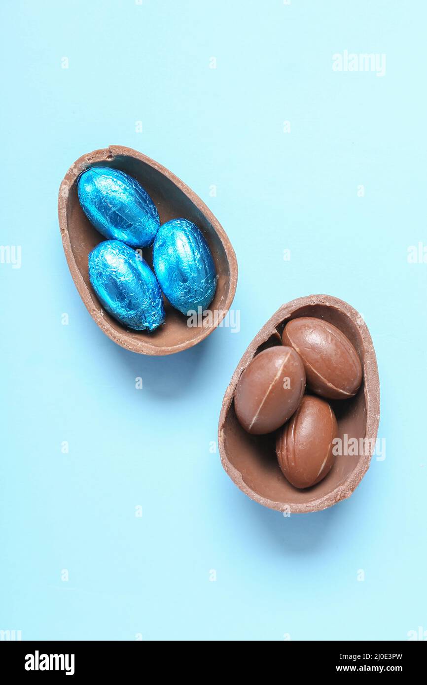 Sweet chocolate eggs on blue background Stock Photo