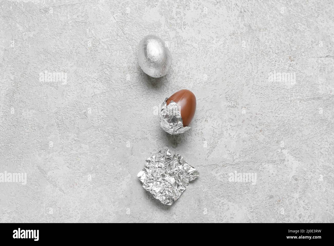 Chocolate eggs in foil on light background Stock Photo