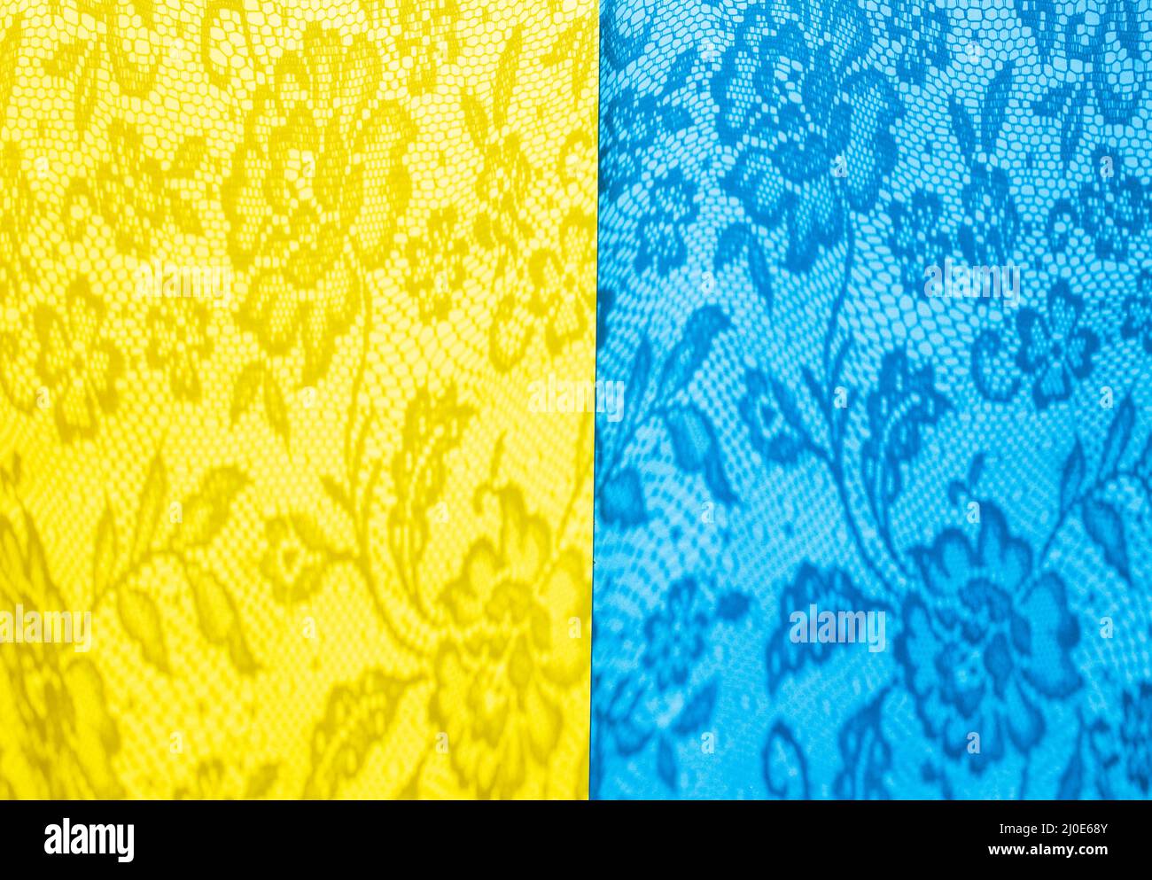 Blue and yellow sheet of paper with openwork shadows. Ukrainian flag colors. yellow-blue background is bisected vertically. Stock Photo