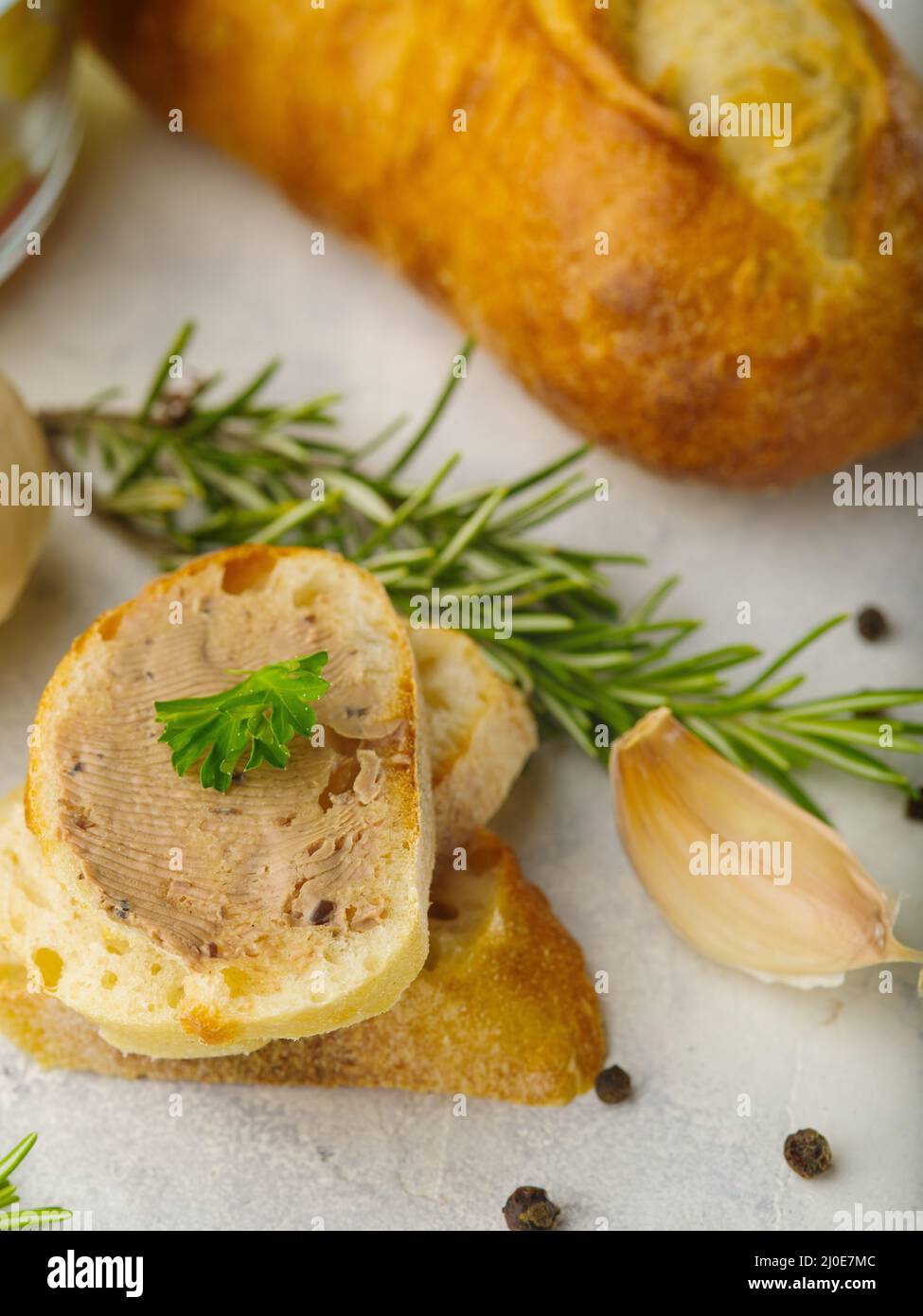Closeup. Canape with foie gras, garlic and rosemary sprigs. in the