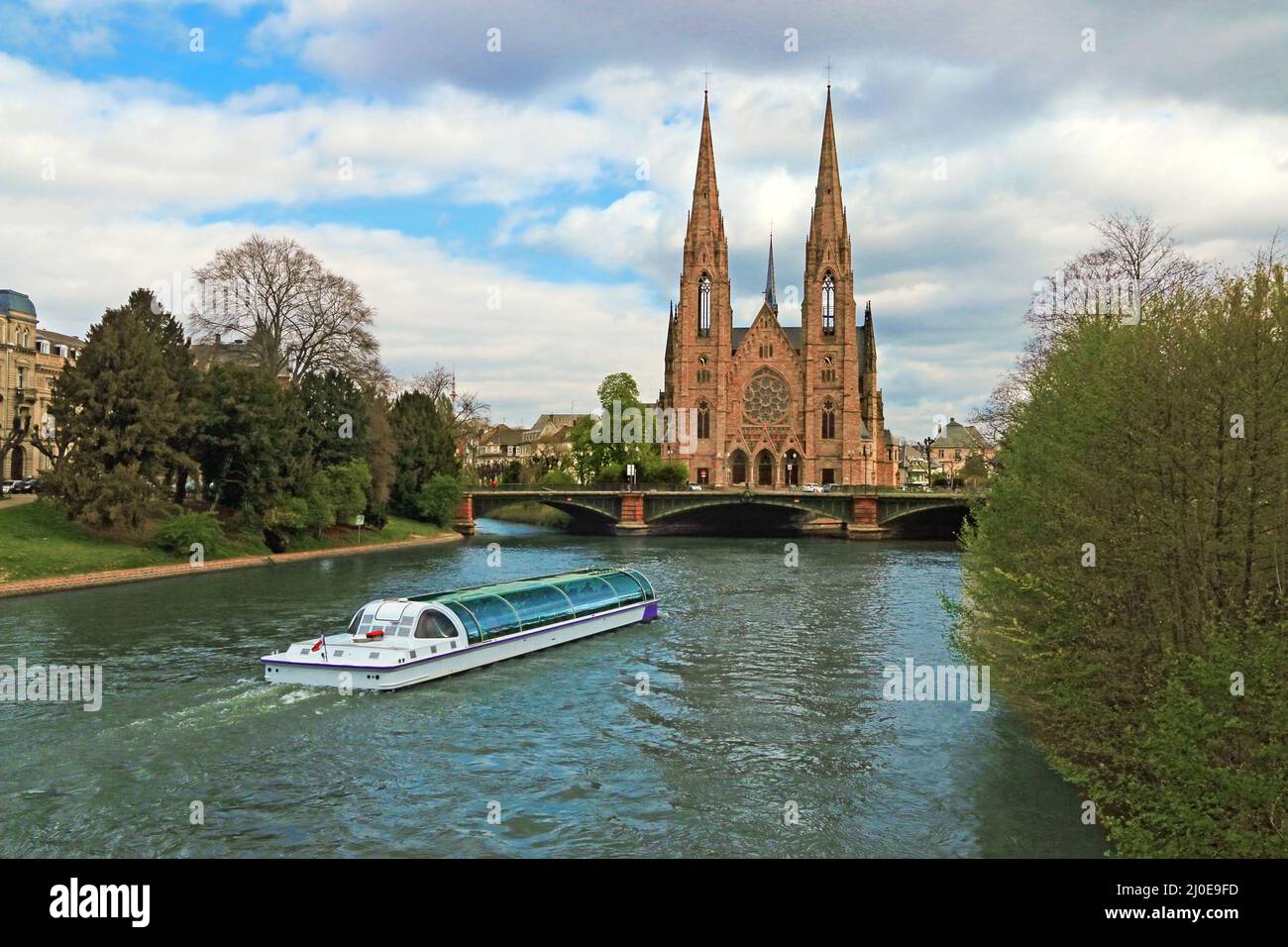 A tourist boat in front of the Saint Paul church in Strasbourg Stock Photo