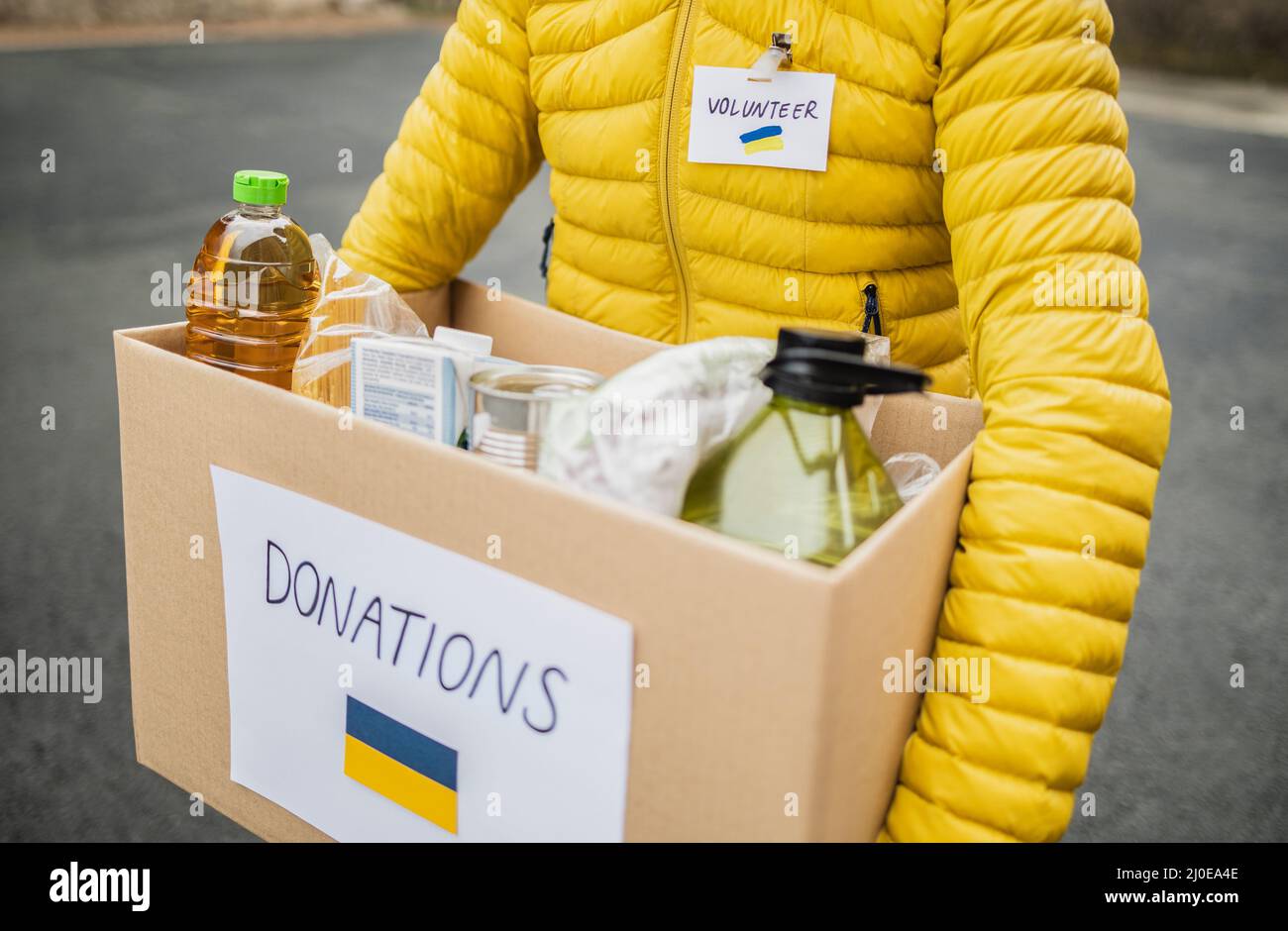 Volunteer collecting box with donations for Ukrainian refugees - Humanitarian aid for Ukrania Stock Photo