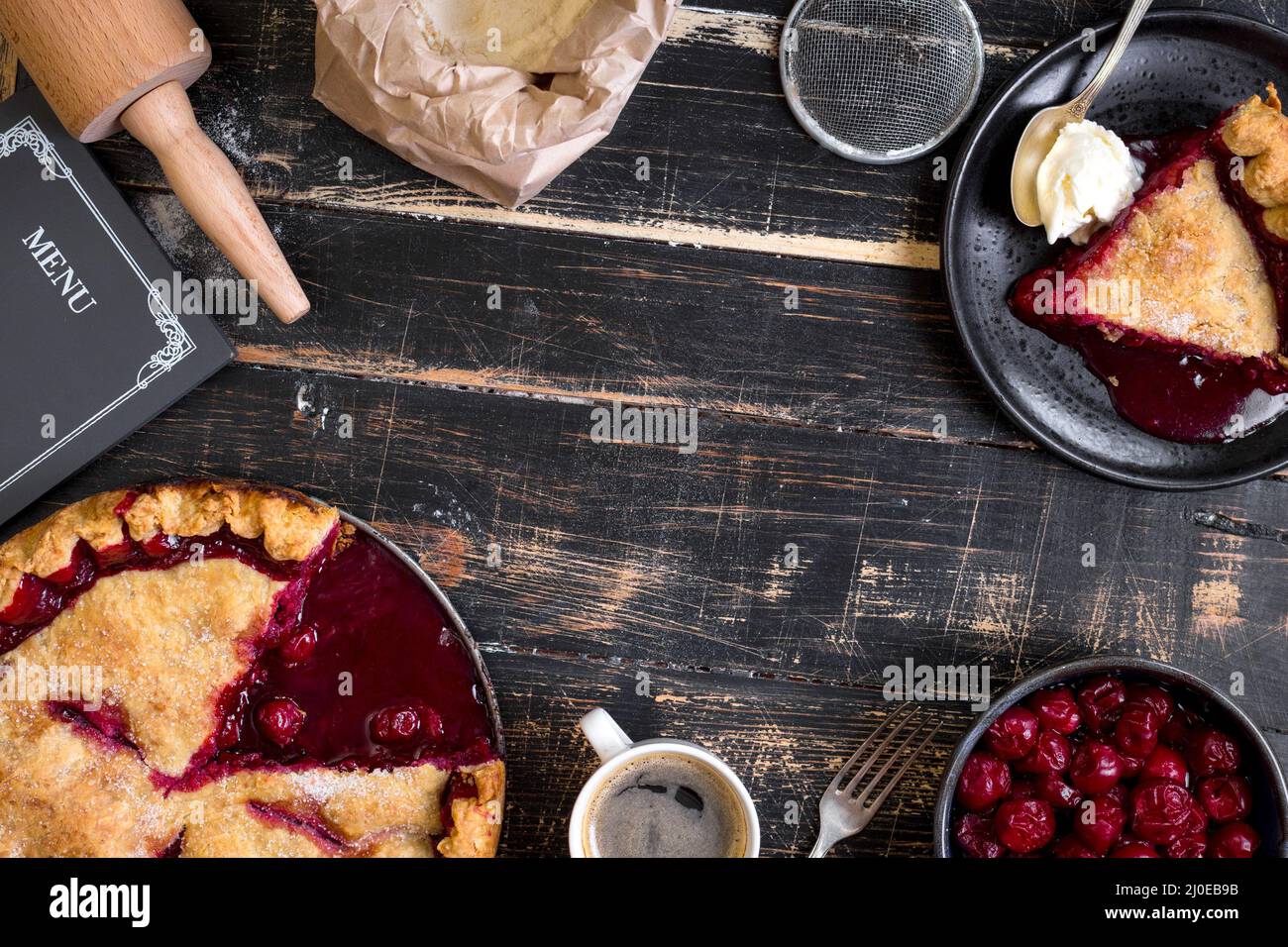 Cherry pie, cup of coffee on dark rustic background Stock Photo