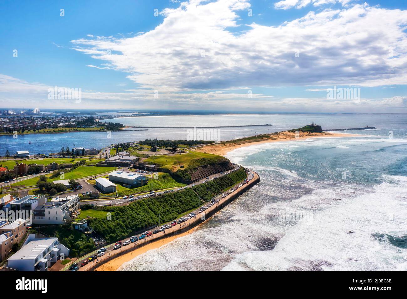 NObbys head lighthouse at the entrance to Newcastle city port and hunter river aerial view. Stock Photo
