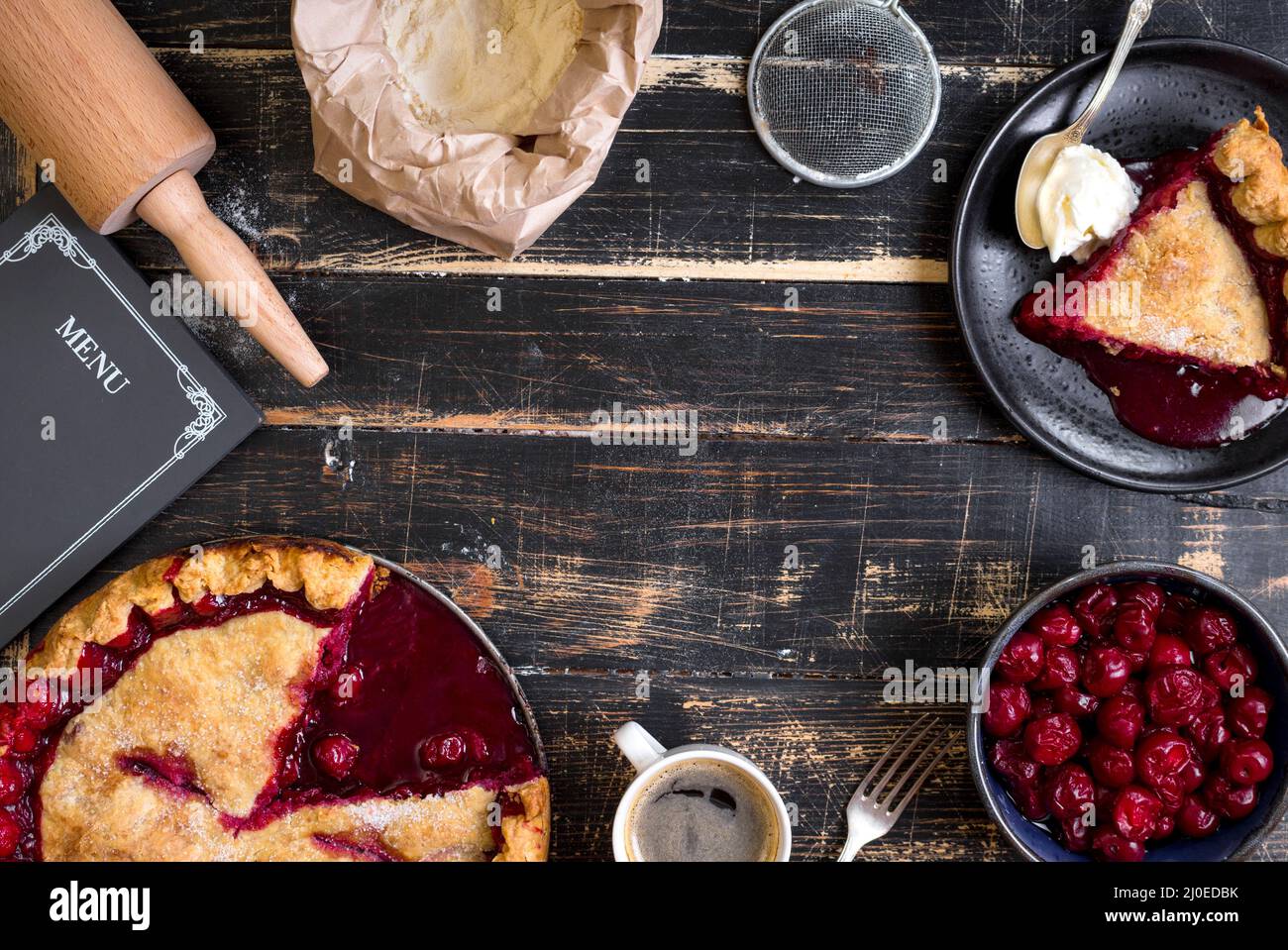 Cherry pie, cup of coffee on dark rustic background Stock Photo