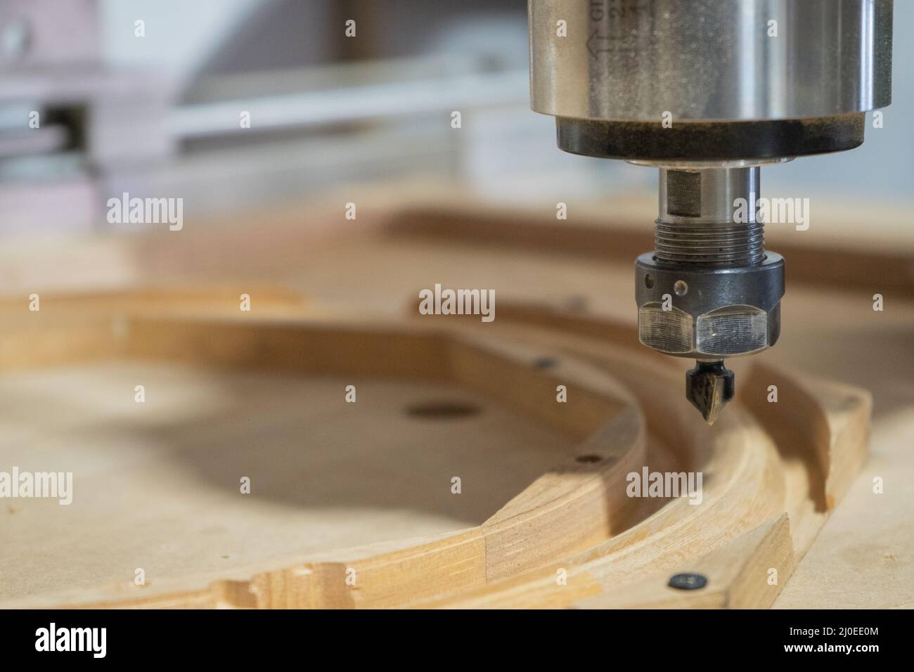 cnc router at work in the workshop making a wooden steering wheel for a classic car Stock Photo