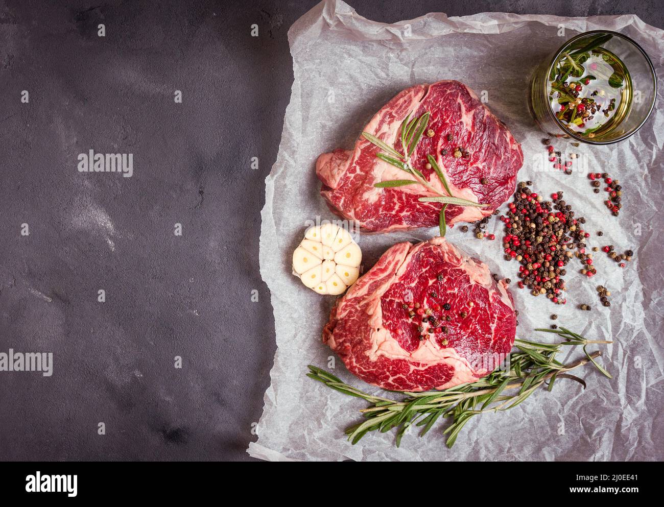 Raw meat steak on rustic concrete background ready to roasting Stock ...