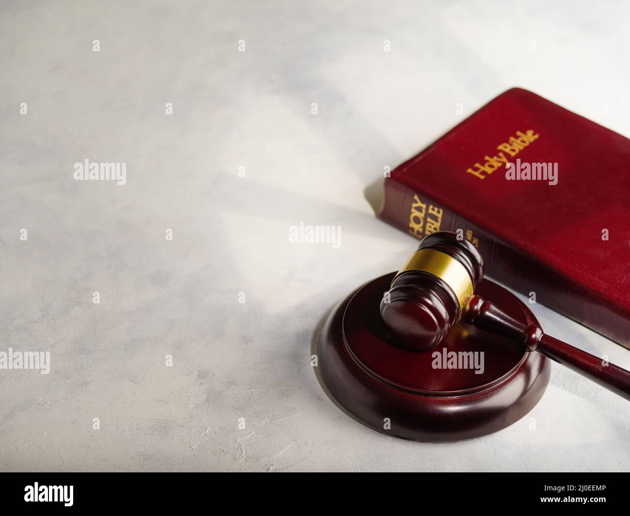 On a white background gavel of the judge and the Bible. Rule of law, judicial system, rule of law, legal practice, Constitution. Minimalism. There are Stock Photo