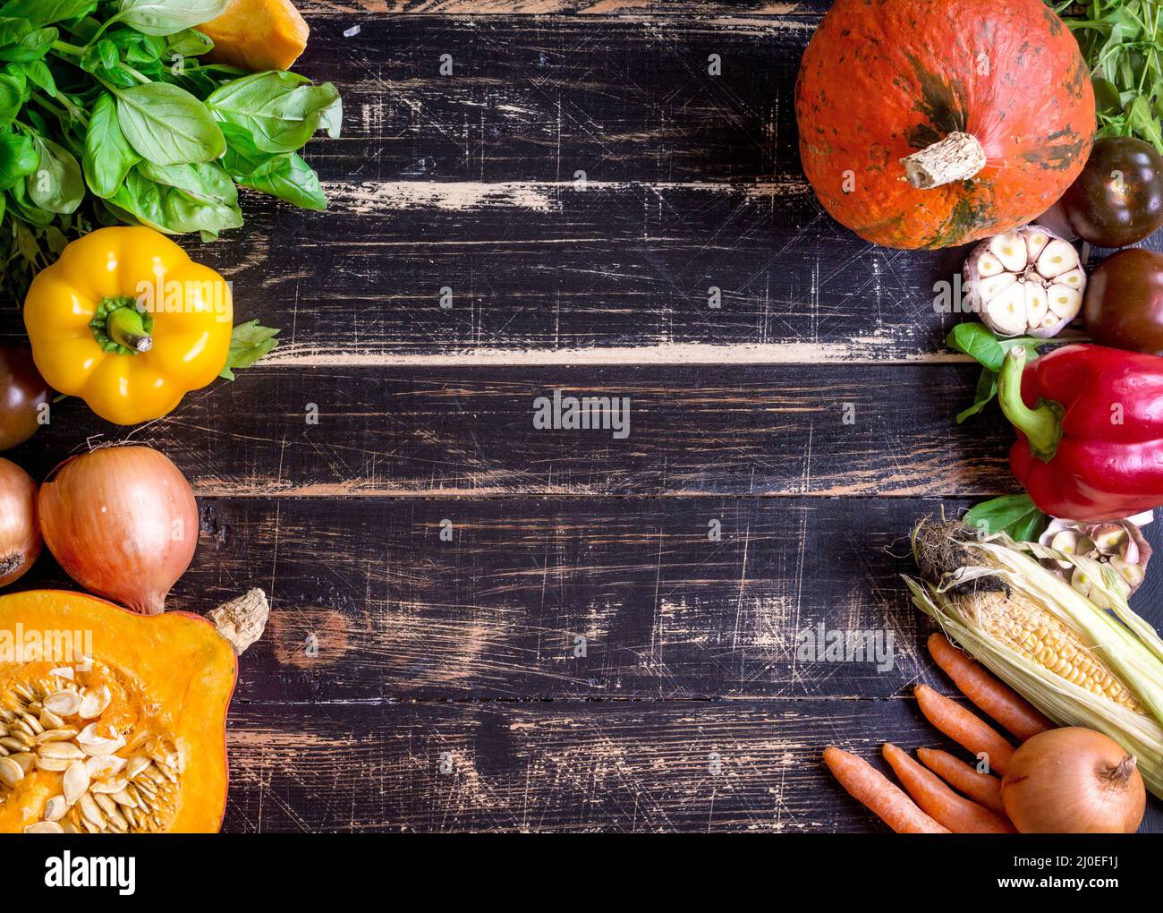 Fresh vegetables on a rustic dark textured table. Autumn background Stock Photo