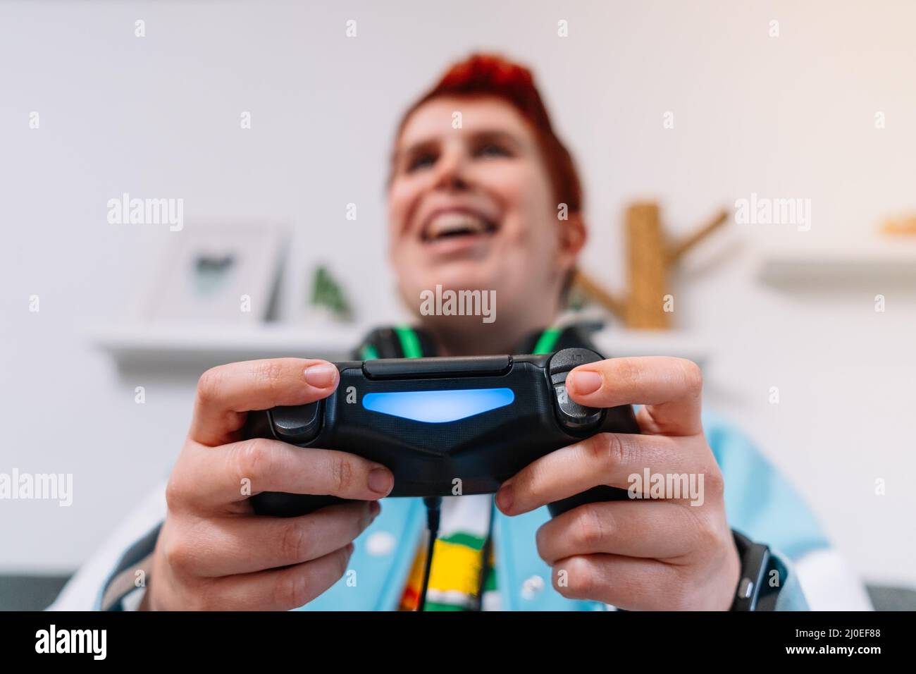 Close-up of the hands of an LGBTQIA person playing a video game console. Stock Photo