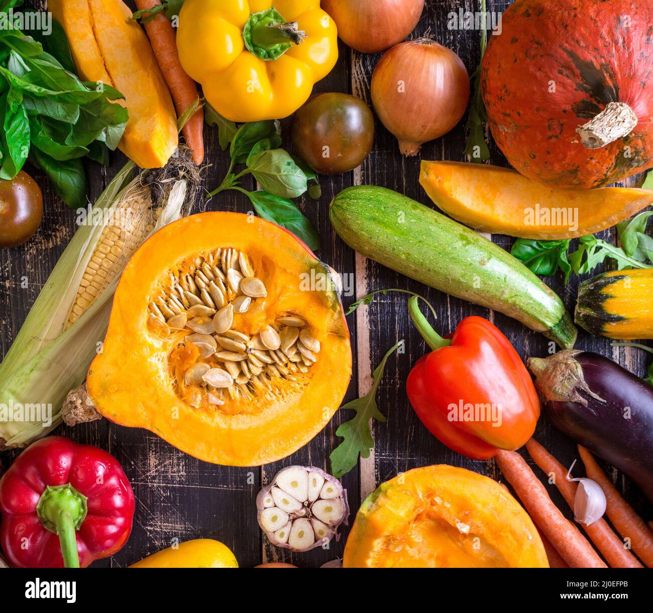 Fresh vegetables on a rustic dark textured table. Autumn background ...
