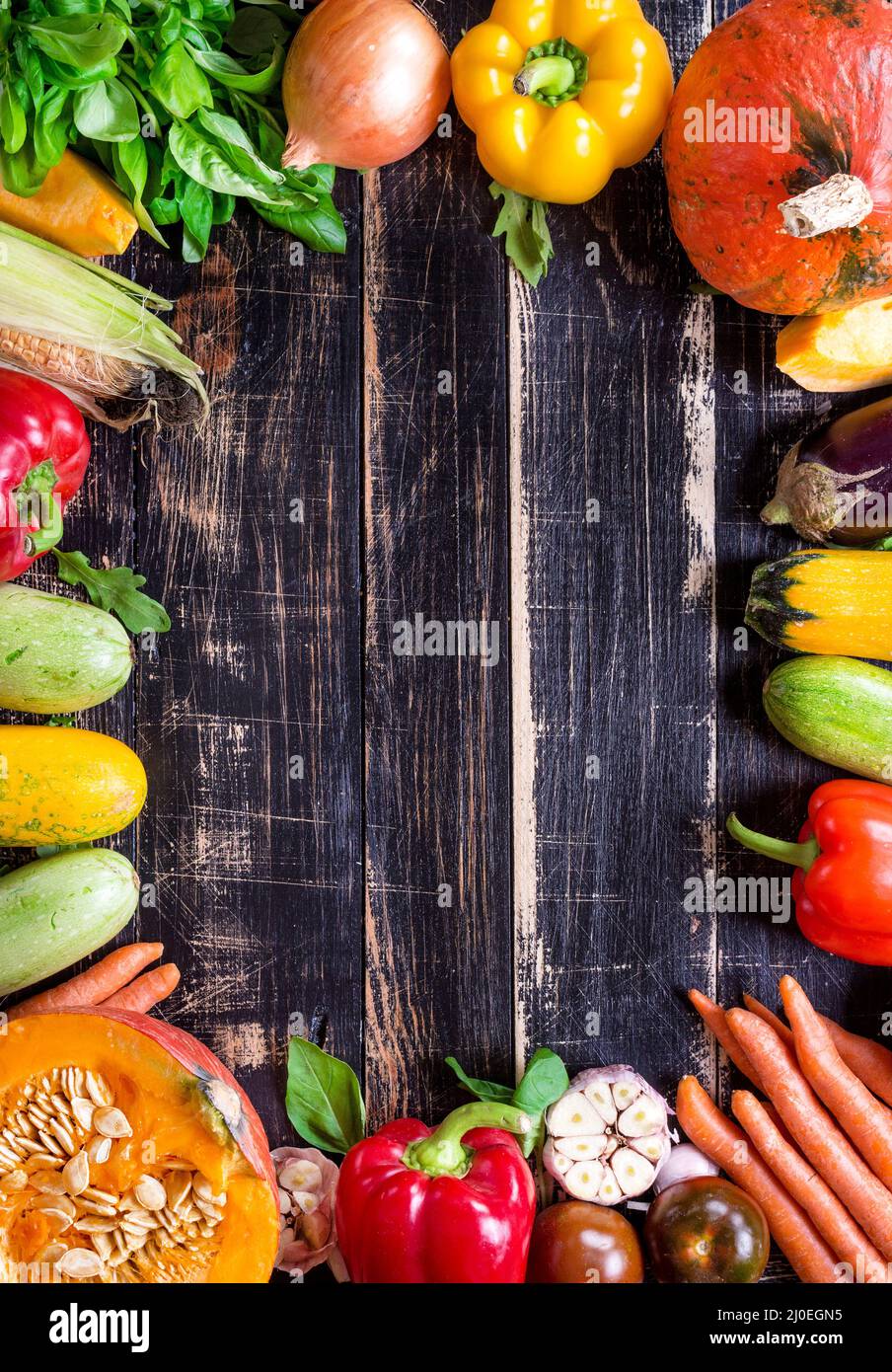 Fresh vegetables on a rustic dark textured table. Autumn background ...