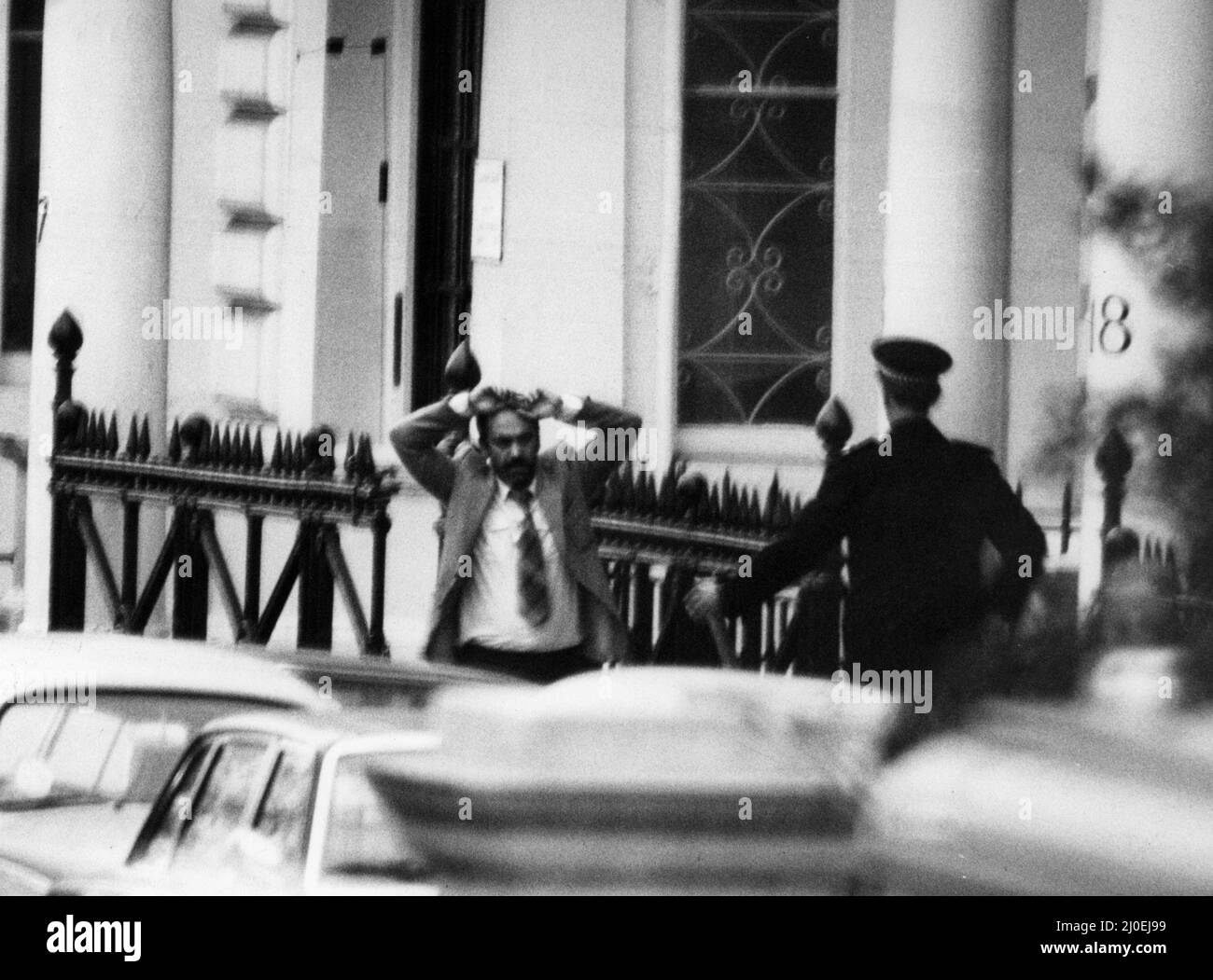 Final day of the Iranian Embassy Siege in London where six gunmen of the Iranian extremist group 'Democratic Revolutionary Movement for the Liberation of Arabistan' stormed the building, taking 26 hostages before the SAS retook the embassy and freed the hostages. One of  the hostages with hands above his head as he is released from the Embassy. 5th May 1980. Stock Photo