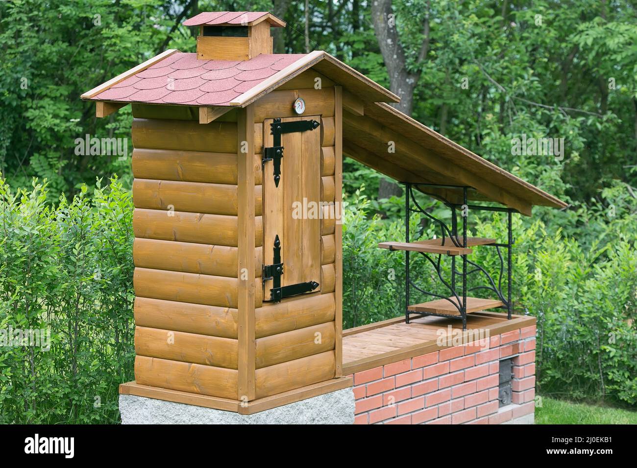 Small homemade smokehouse with stone base and long inlet flue Stock ...