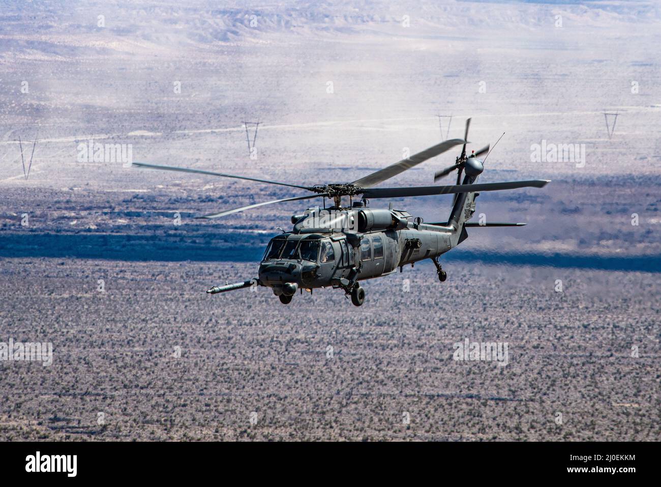 An HH-60 Pave Hawk assigned to the 55th Rescue Squadron, participates in a combat search and rescue exercise during Red Flag-Nellis 22-2, at the Nevada Test and Training Range, March 10, 2022. The Nevada Test and Training Range is the U.S. Air Force’s premier military training area with more than 12,000 square miles of airspace and 2.9 million acres of land. (U.S. Air Force photo by Airman Trevor Bell) Stock Photo