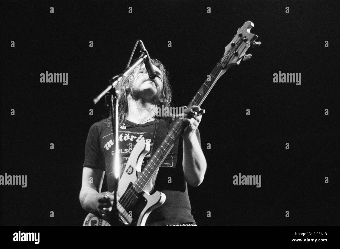 Ian Lemmy Kilmister founder and lead singer with the band Motorhead, seen here performing on stage at the Reading Rock Festival. 24th August 1979 Stock Photo