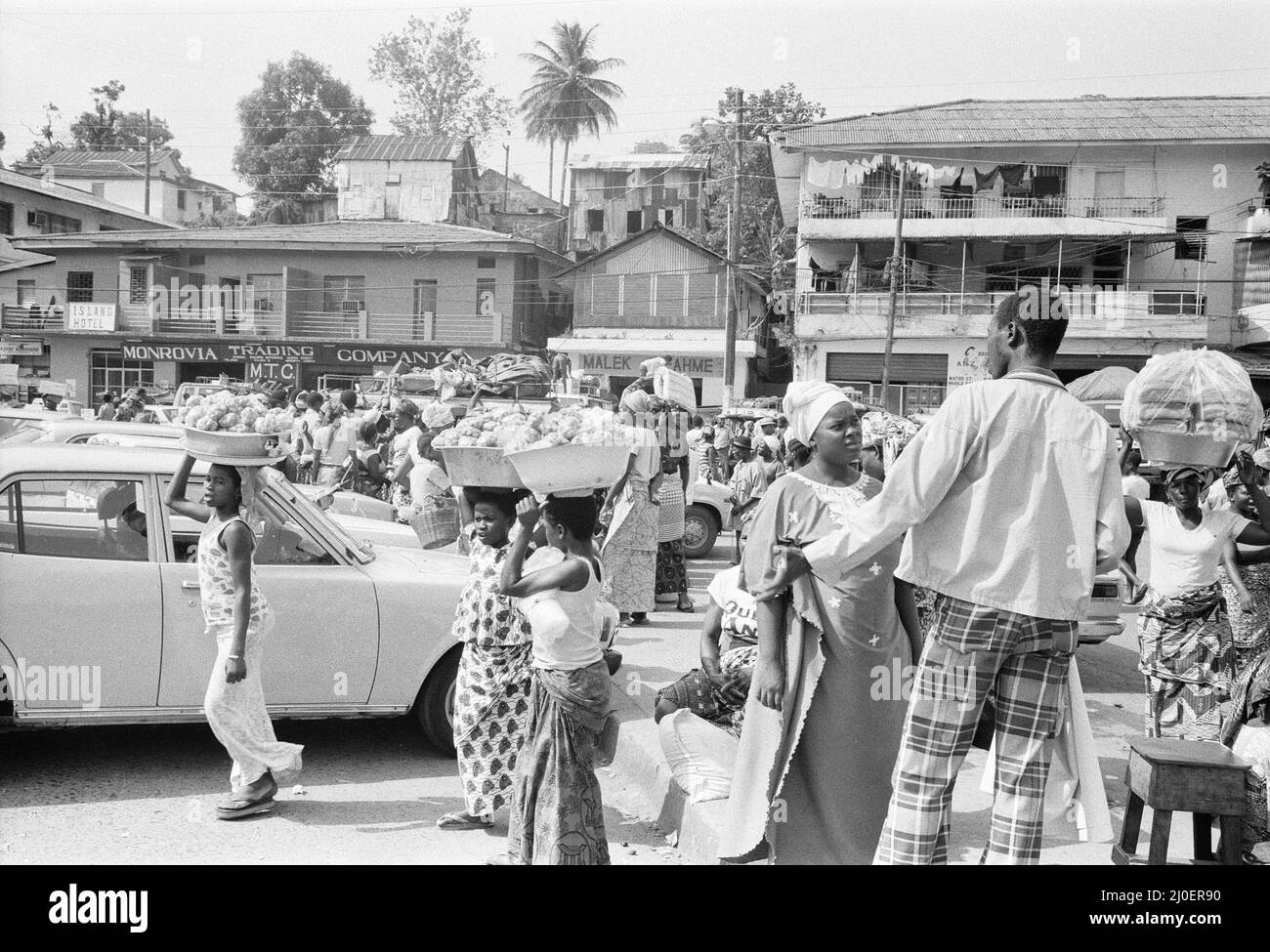 Market traders on Water Street Monrovia, Liberia buying and selling food March 1980 Stock Photo