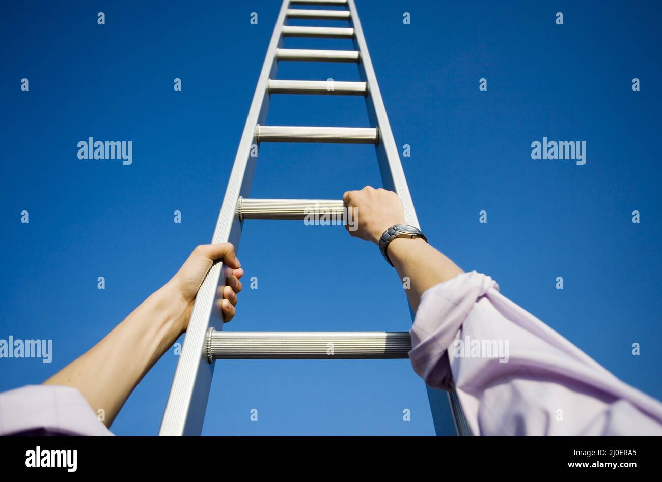 Personal perspective of a businessman climbing a ladder themes of point of view success motivation Stock Photo