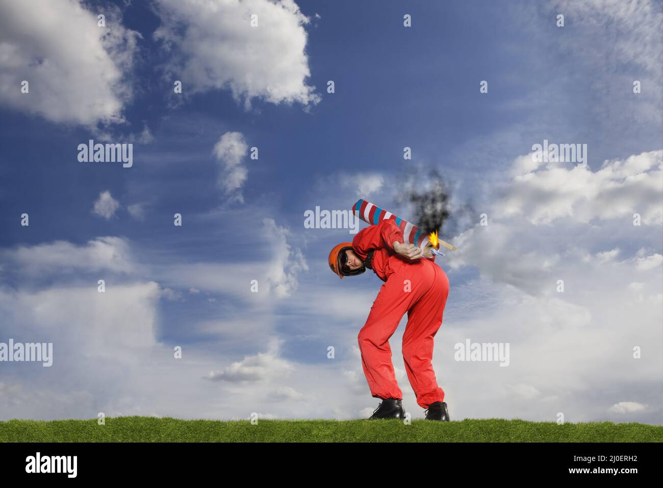 Stuntman igniting a rocket strapped to his back Stock Photo