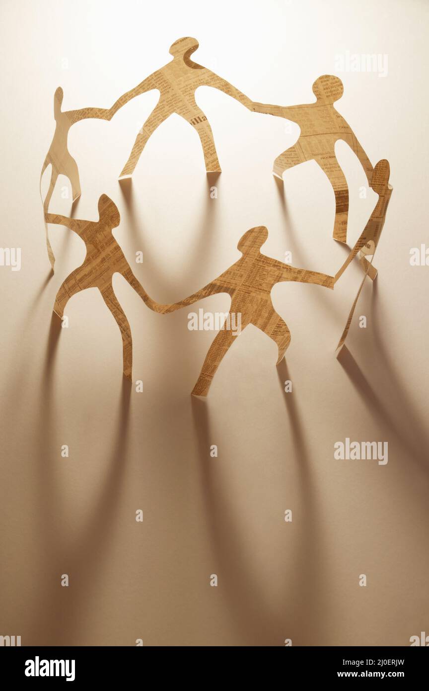 Paper dolls holding hands Stock Photo Alamy