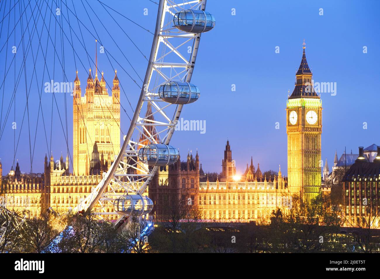 Houses of Parliament and London Eye at dusk Stock Photo