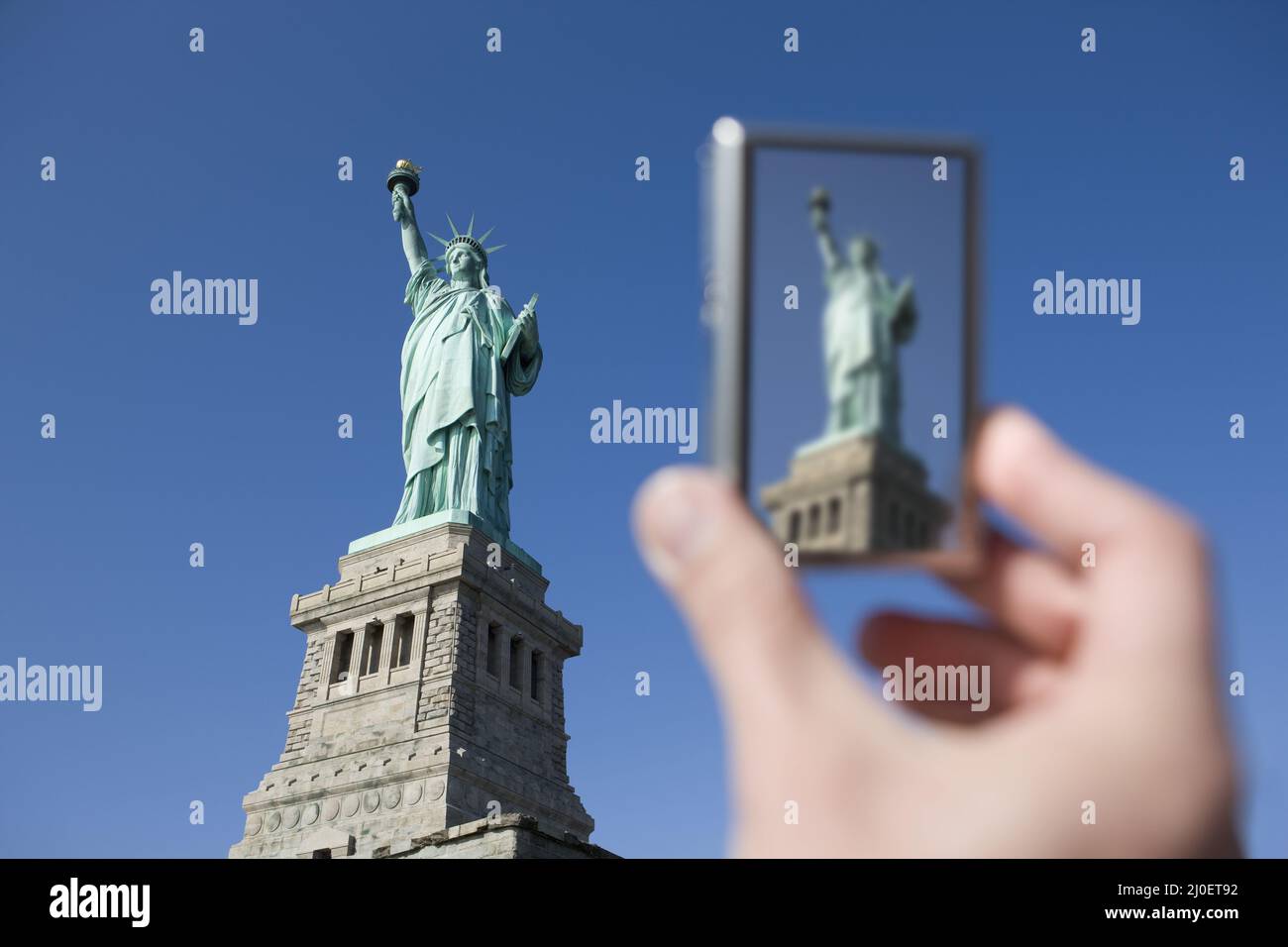 Personal perspective of tourist photographing Statue of Liberty with digital camera new york city ne Stock Photo
