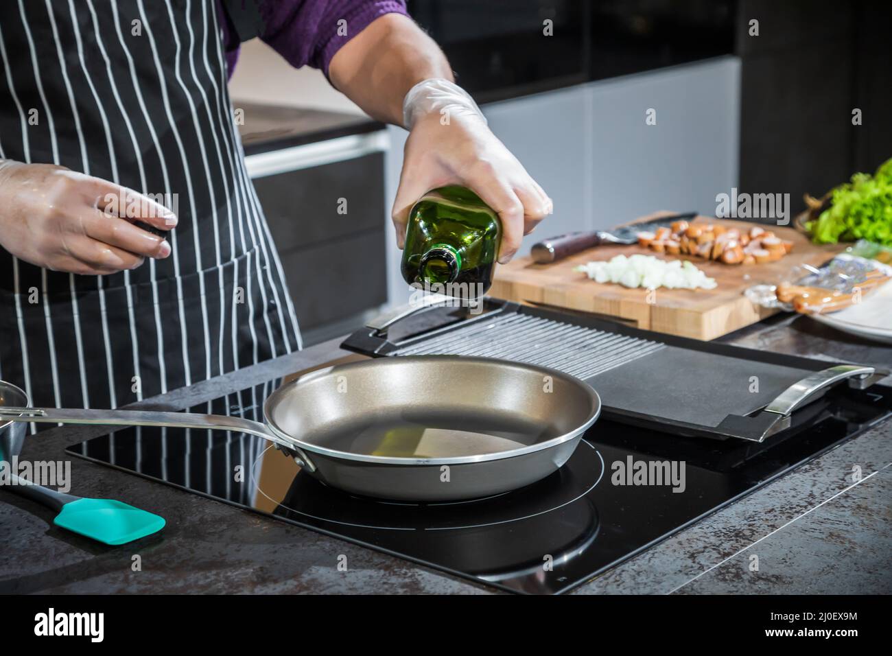 Cook pours vegetable oil in a pan Stock Photo Alamy