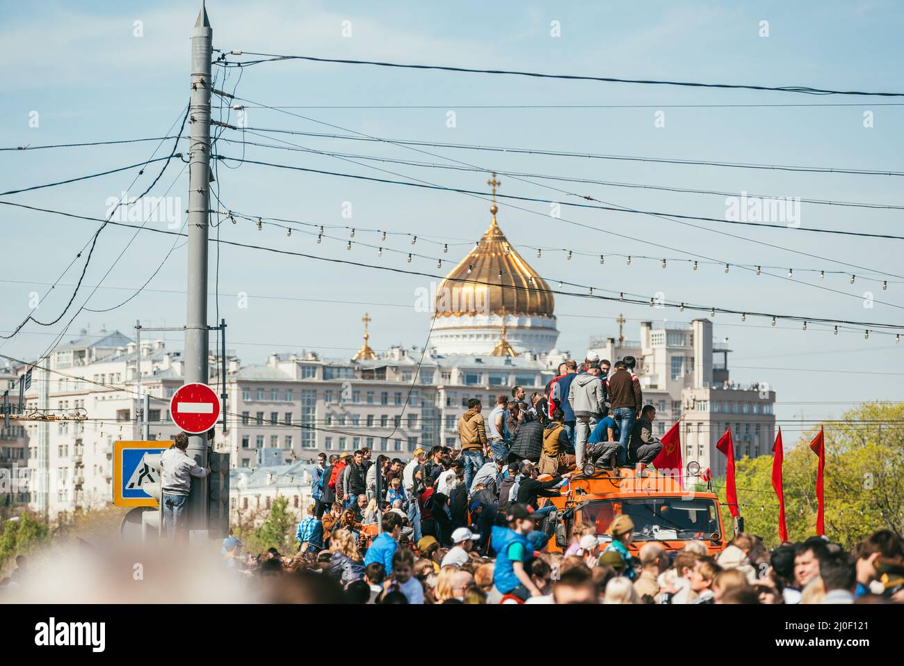 MOSCOW, RUSSIA-MAY 09, 2015: People celebrate Victory Day May 9 in Bol'shoy Moskvoretskiy Most. People climb on an orange truck Stock Photo