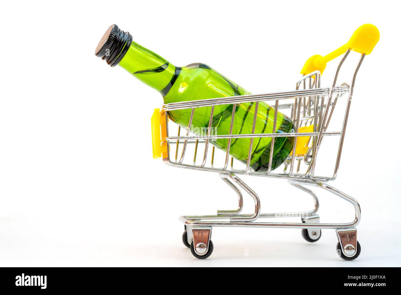 Selling alcohol in a store. Green bottle in a supermarket cart. Drink