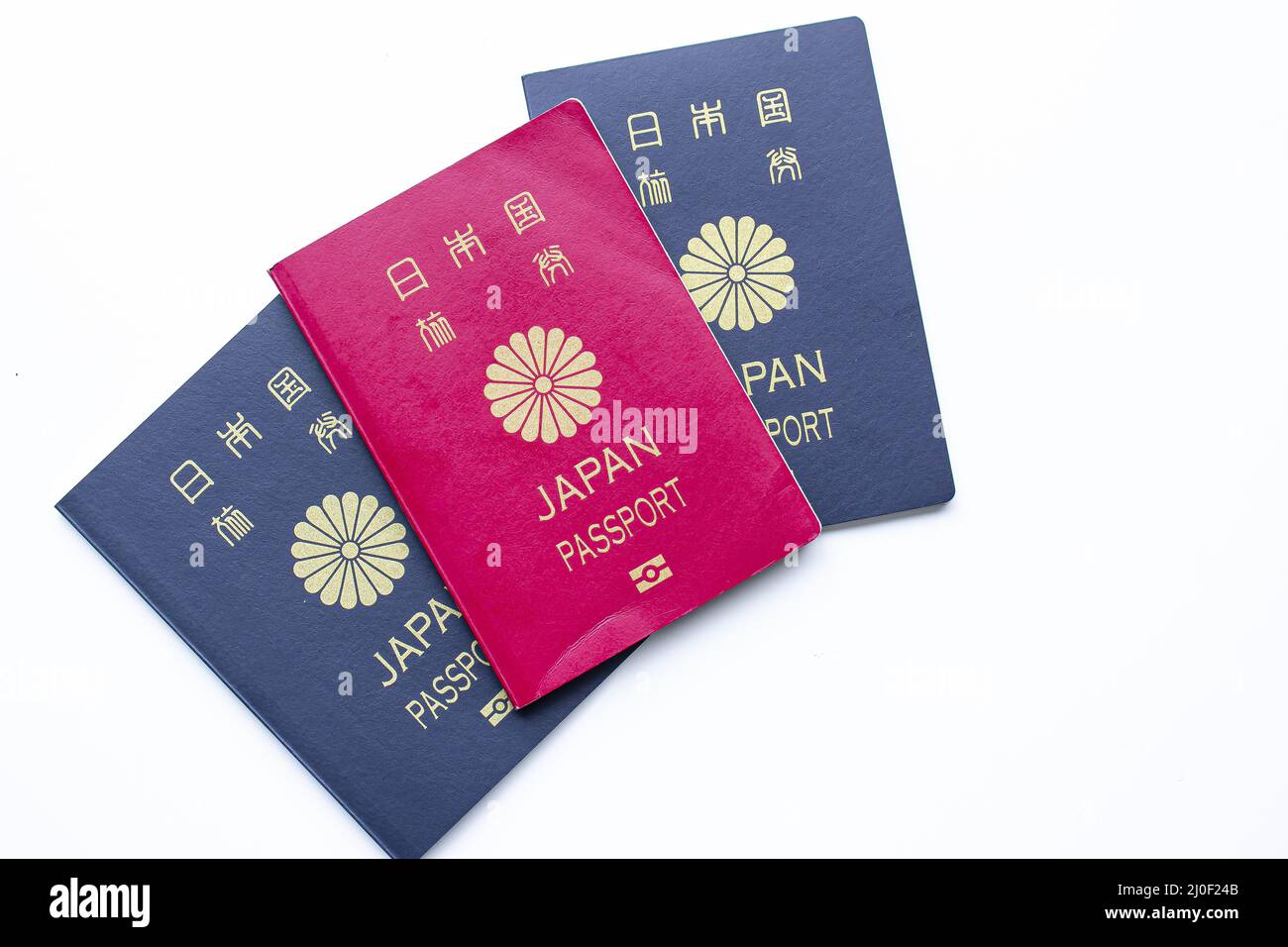 Japanese red and dark passports on a white background Stock Photo Alamy