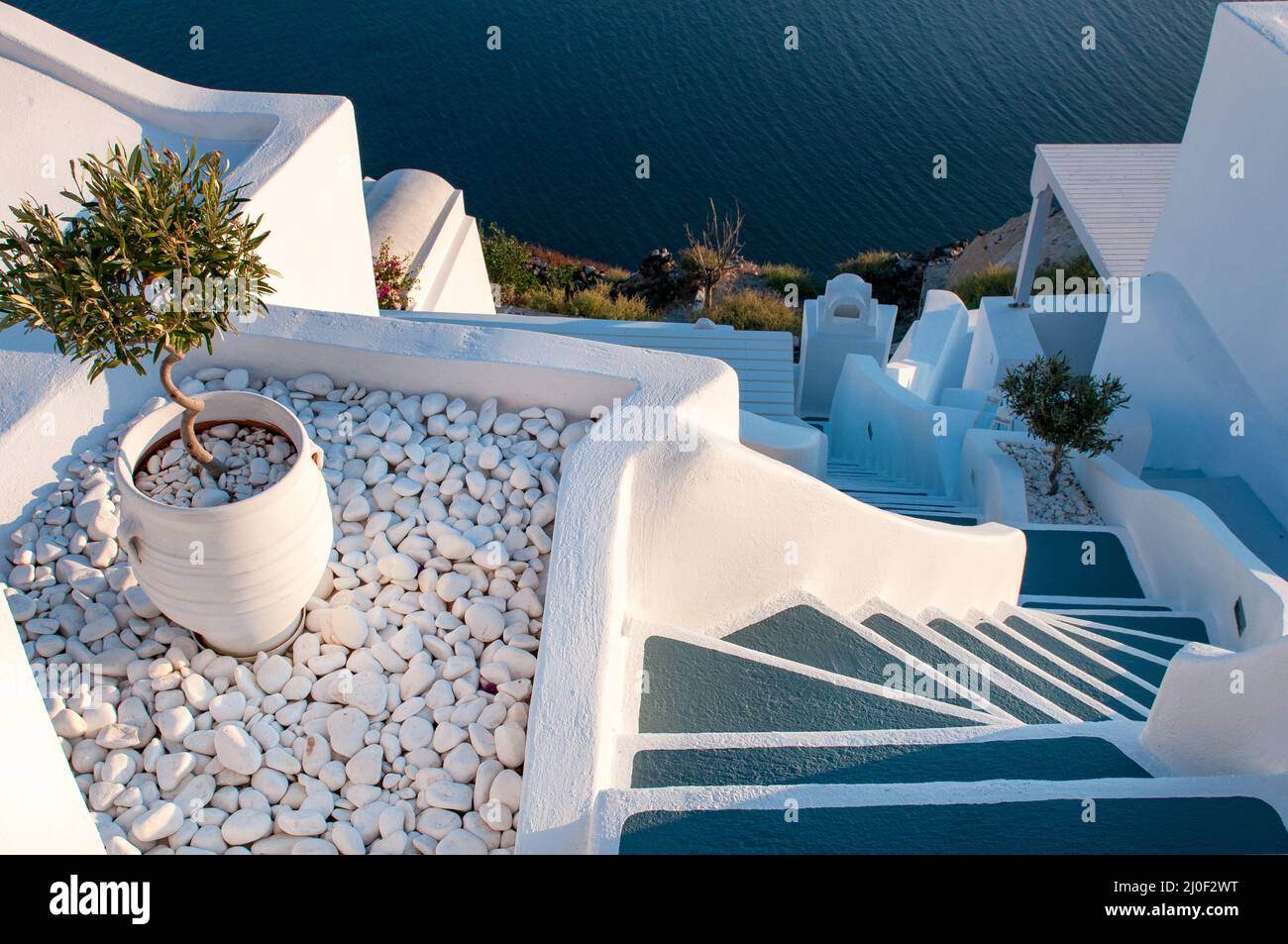 Traditional narrow stair street leading to the sea. Oia village, in Santorini Island, Greece. Stock Photo