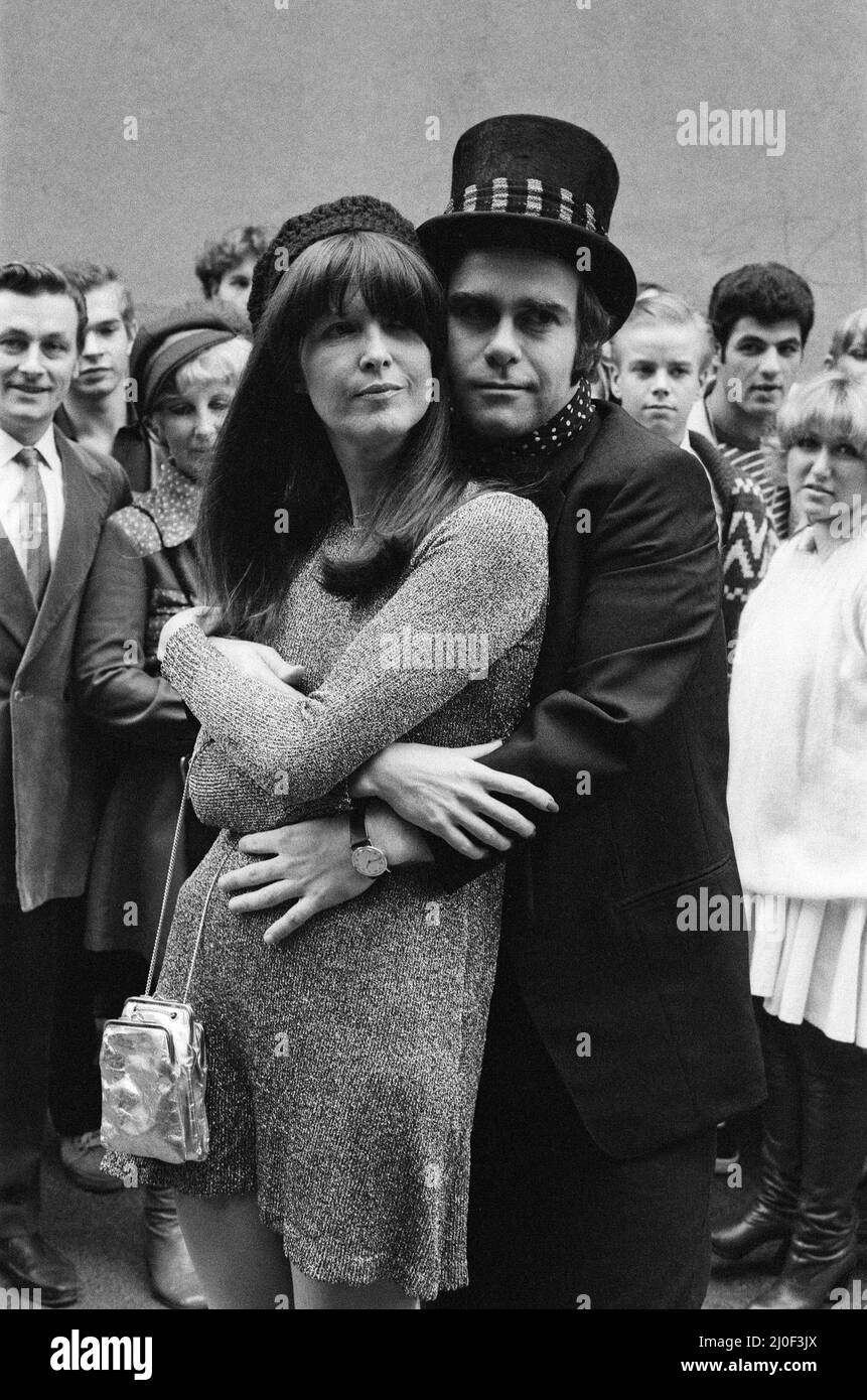 Wearing a top hat, Elton John, at a small studio in Ladbroke Grove to make a promotional film for his new single. Giving the film the feeling of the 1960's in the style of 'Ready Steady Go', Elton invited Cathy McGowan to take part. 5th October 1978. Stock Photo