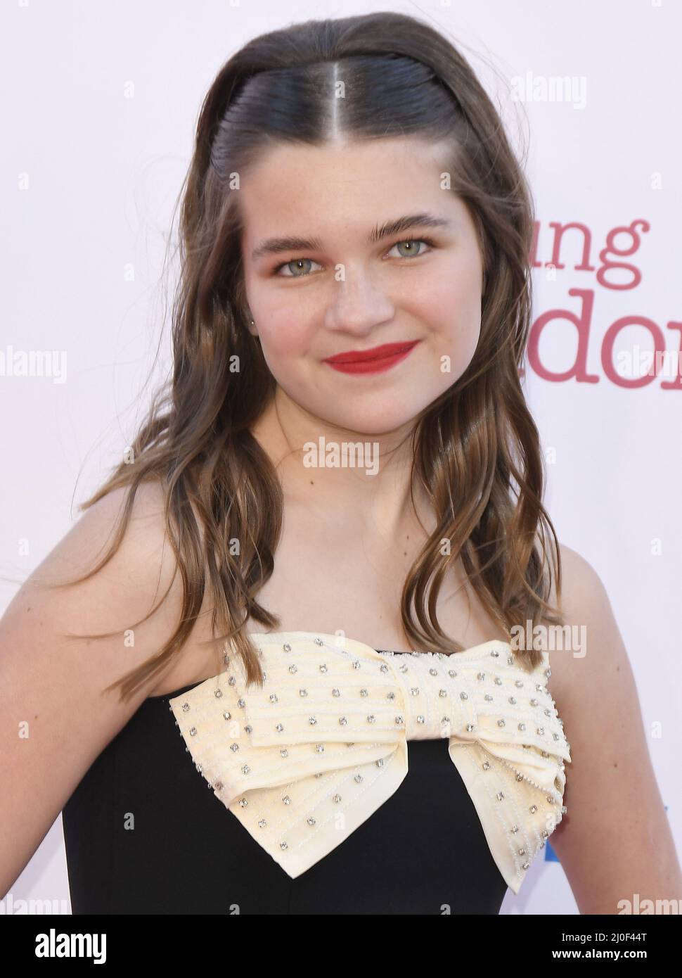 Raegan Revord arrives at the Premiere Of Warner Bros. 100th Episode Of
