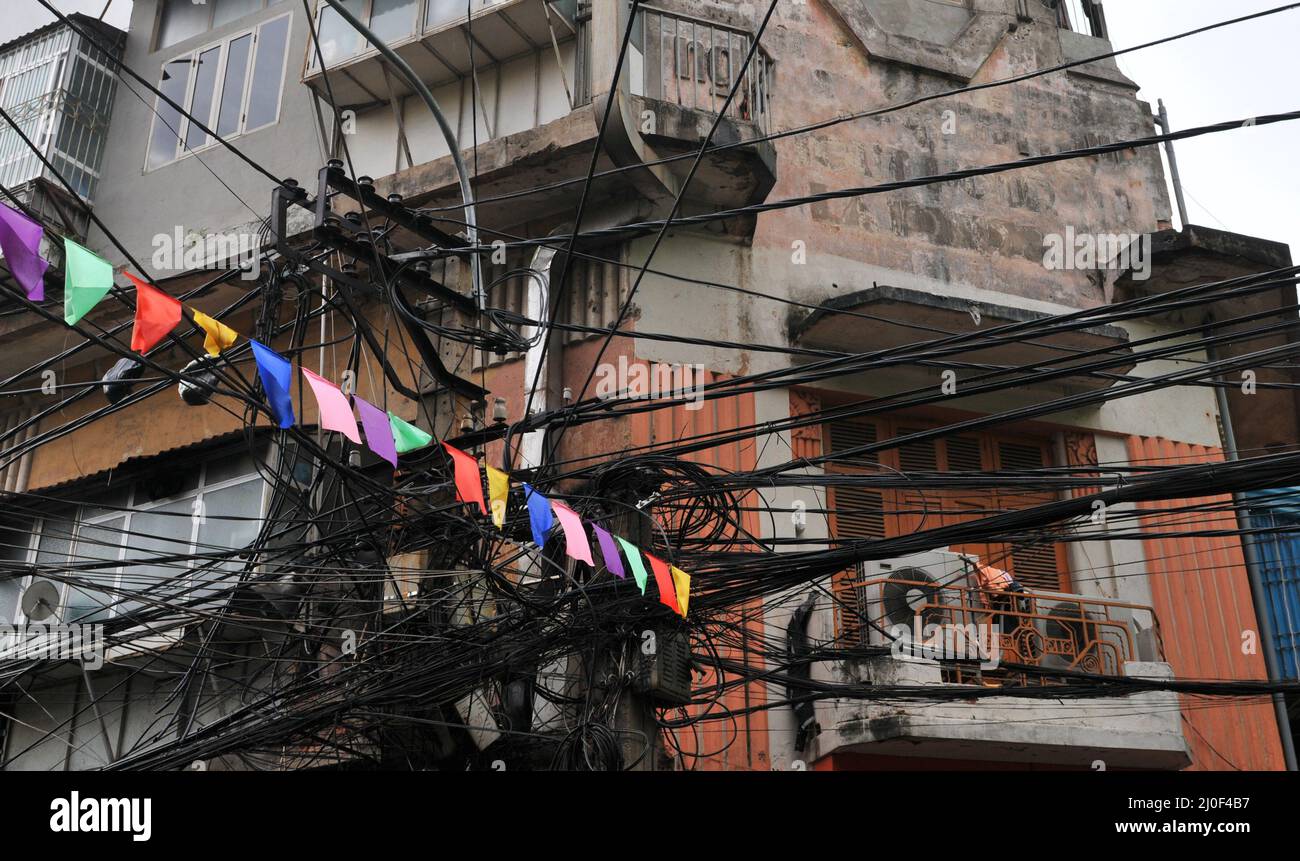 Messy entangled electricity supply and, telecommunication wires, cables, Hanoi, Vietnam Asia Stock Photo