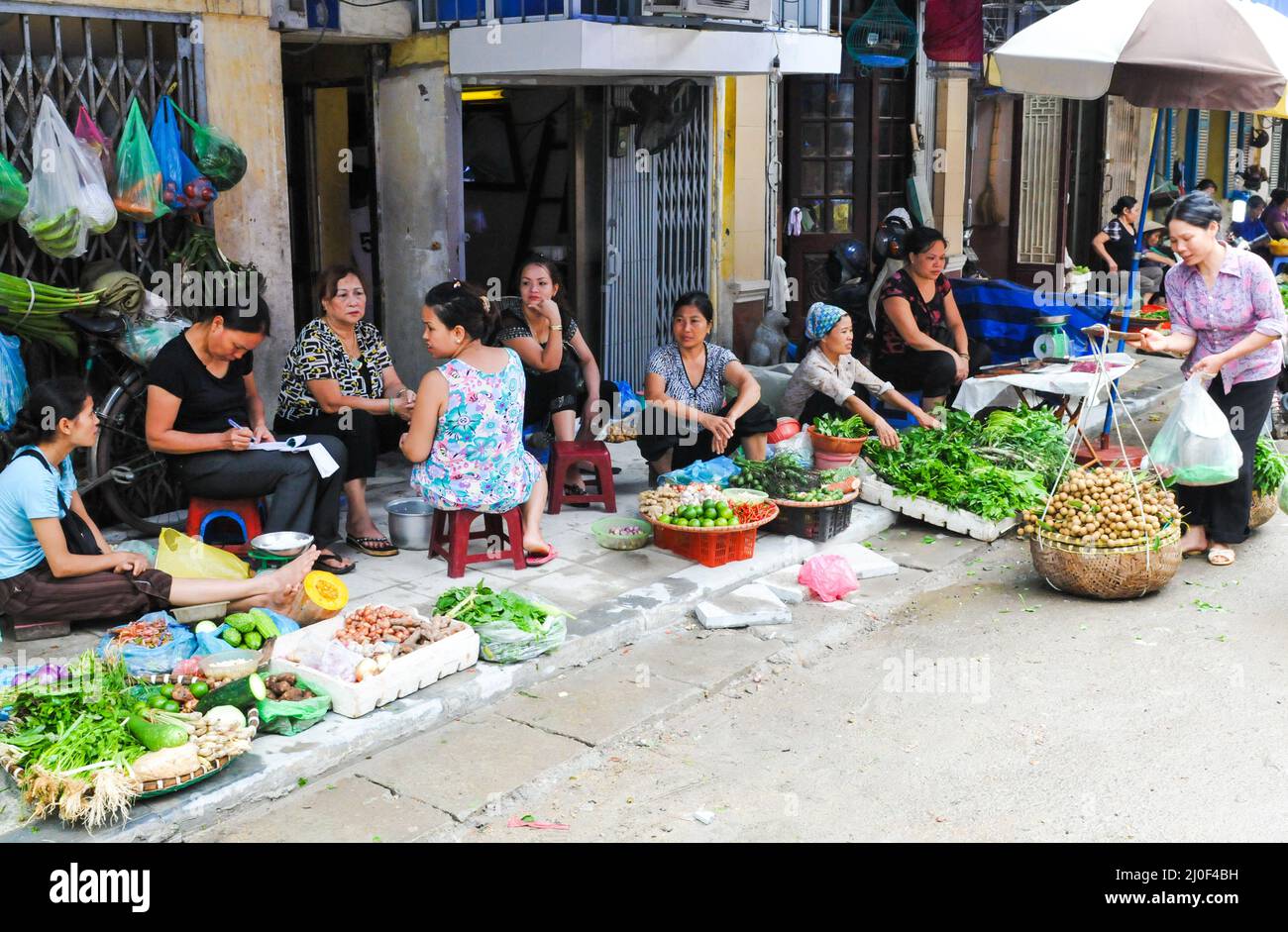 Vietnamese women selling healthy and fresh vegetables. Hanoi Vietnam Asia Stock Photo