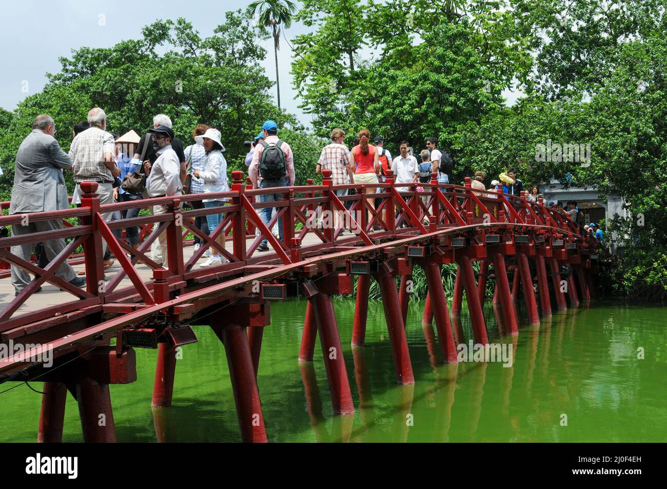 People walking on  The Huc red bridge leading to Jade island. Hanoi, Vietnam Stock Photo