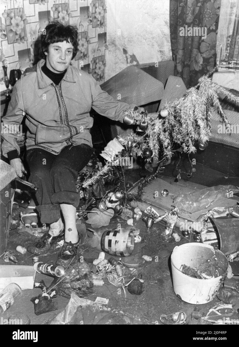 Welsh Floods 1979, Our picture shows ... The aftermath of Christmas, Mrs Mary Milton clears up in the damaged front room of her home in Trehafod, 27th December 1979. Stock Photo