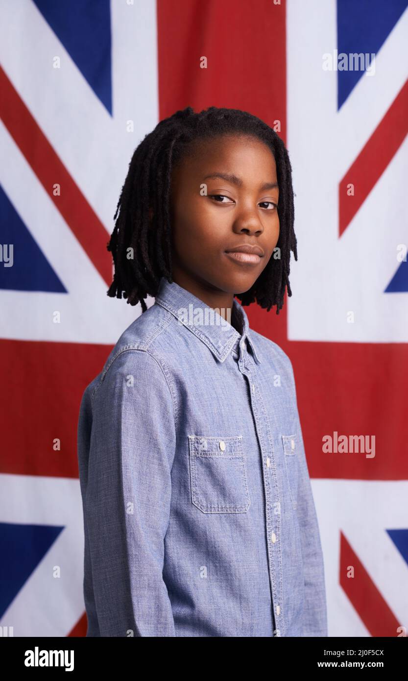 National pride. Portrait of a proud young boy standing in front of the Union Jack. Stock Photo