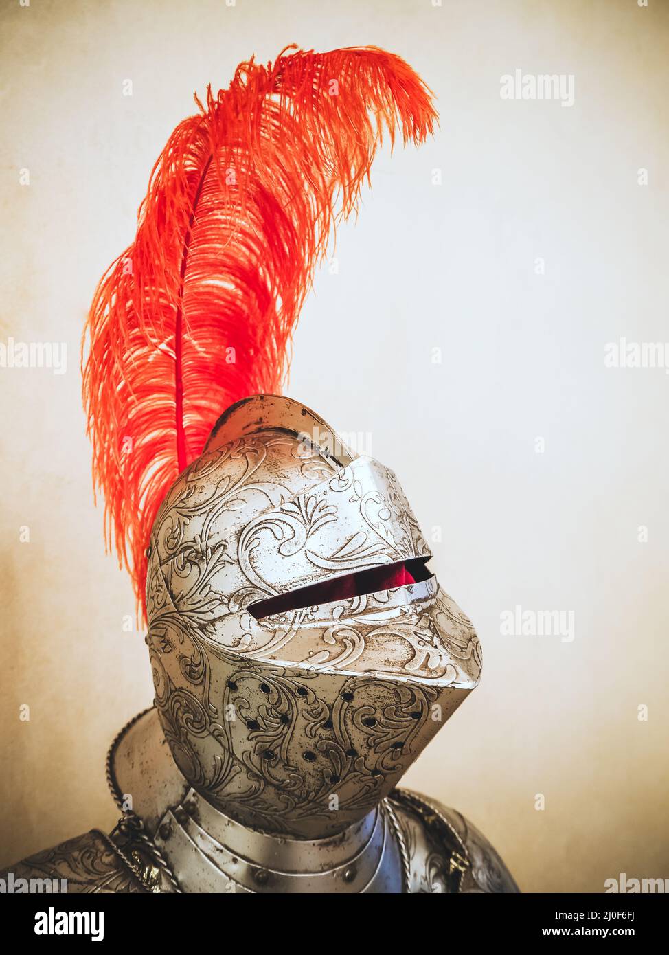Russia, Sochi 14.03.2020. A medieval knight's metal helmet with patterned chasing and a long ostrich red feather Stock Photo