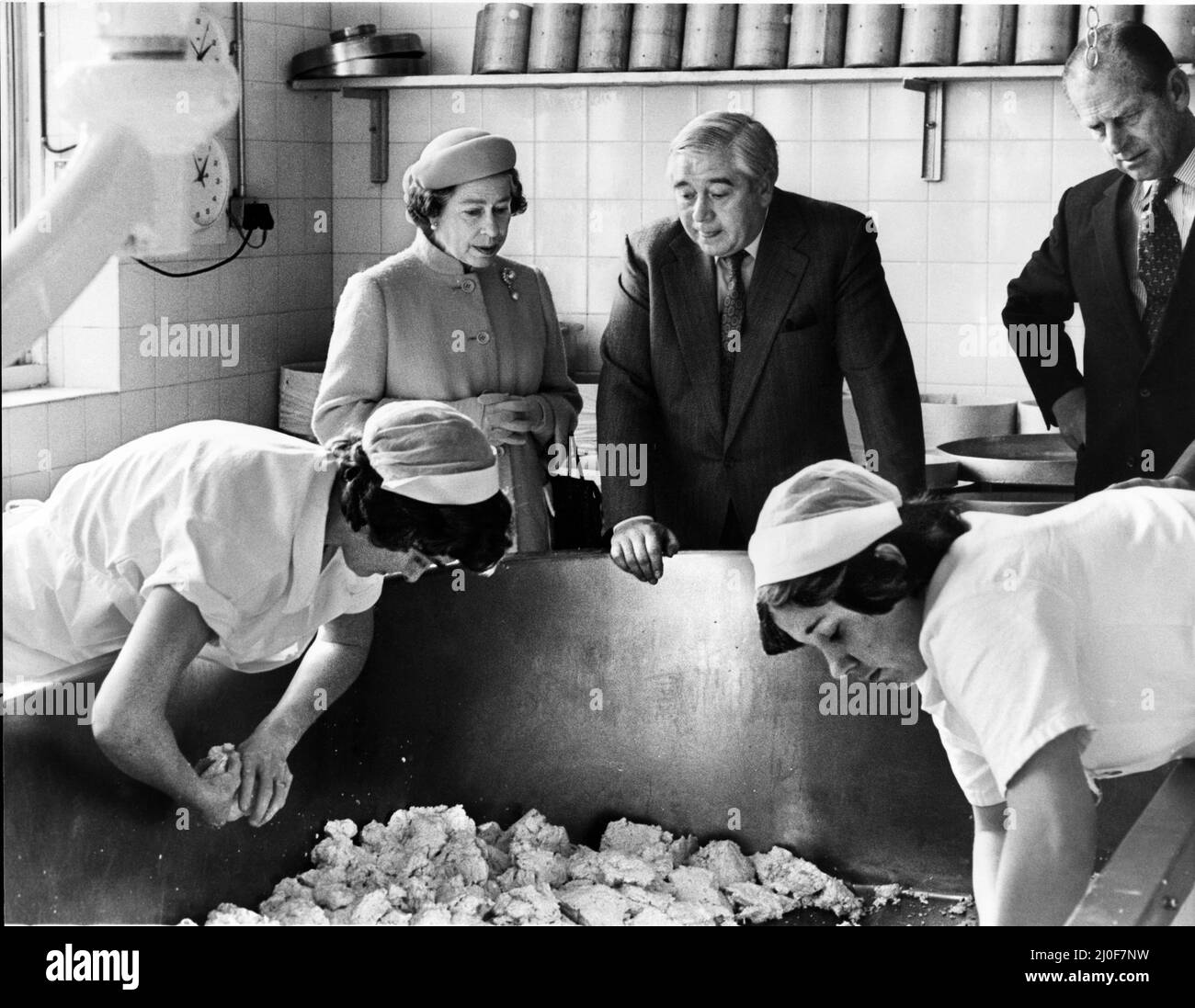 Queen Elizabeth II visits Mollington Grange Cheese Farm,Mollington, Chester. Mr Oulton Wade explains one of the cheese making processes.  Picture taken 2nd November 1979 Stock Photo