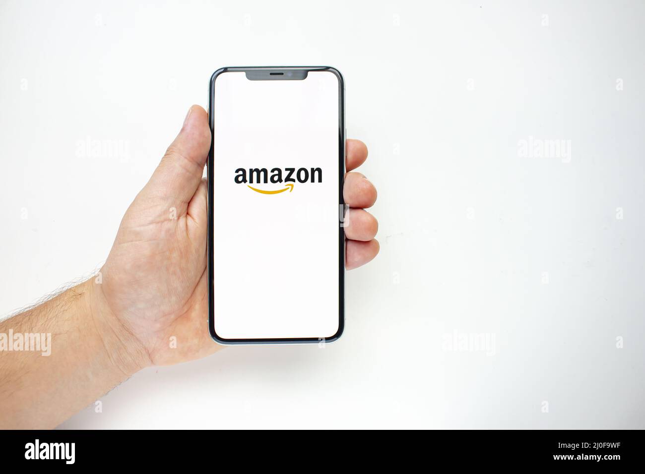 Calgary, Alberta, Canada. Aug 15, 2020. A person holding an iPhone 11 Pro Max with the Amazon App Stock Photo