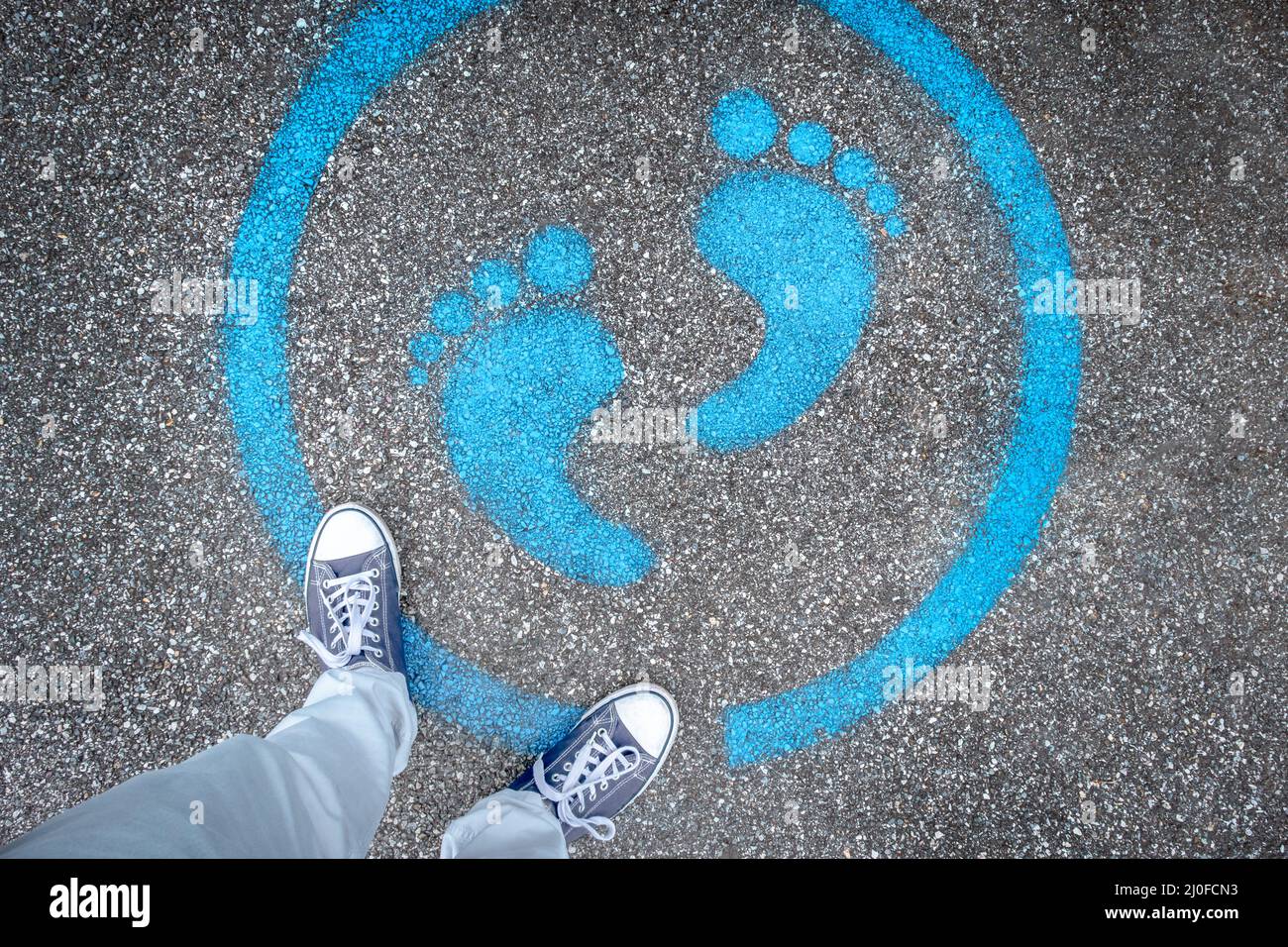 Man standing on blue dot Stock Photo