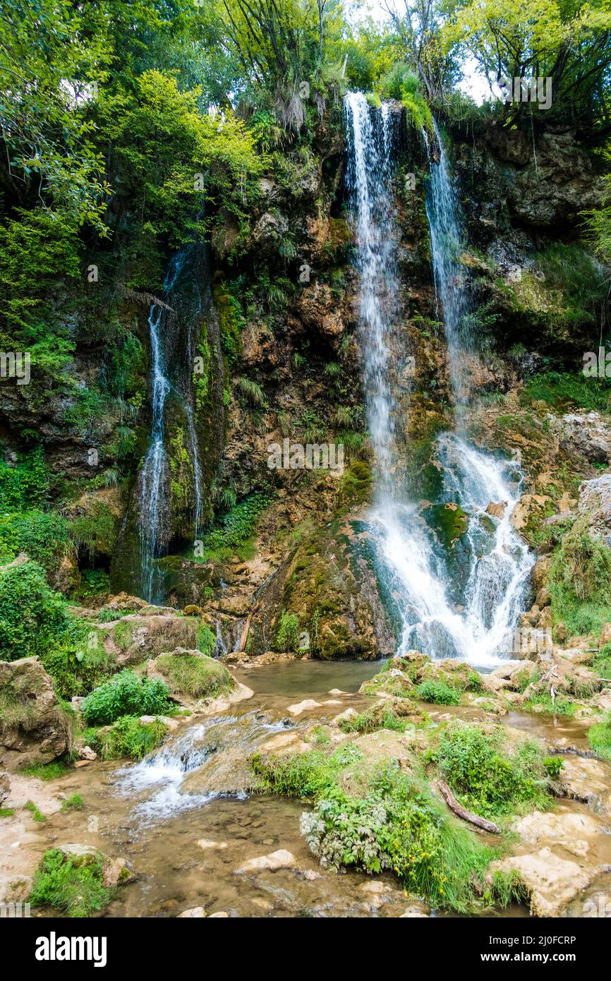 Scenic view of waterfalls in the middle of the forest Stock Photo - Alamy