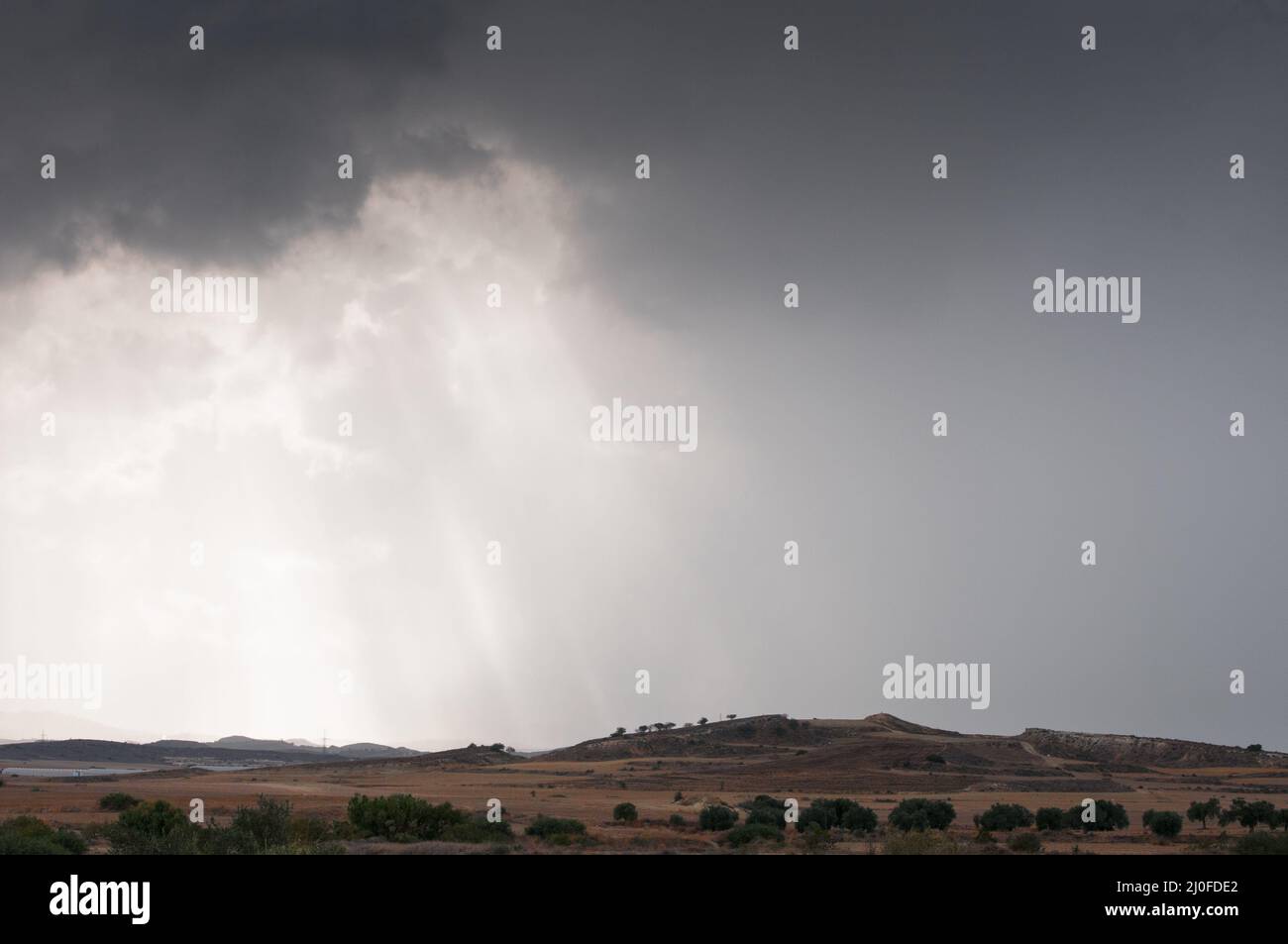 Clouds and sunrays in winter with stormy sky Stock Photo