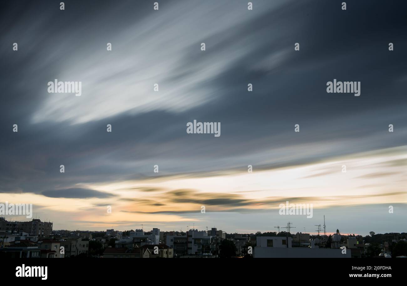 Moving clouds during sunset Stock Photo