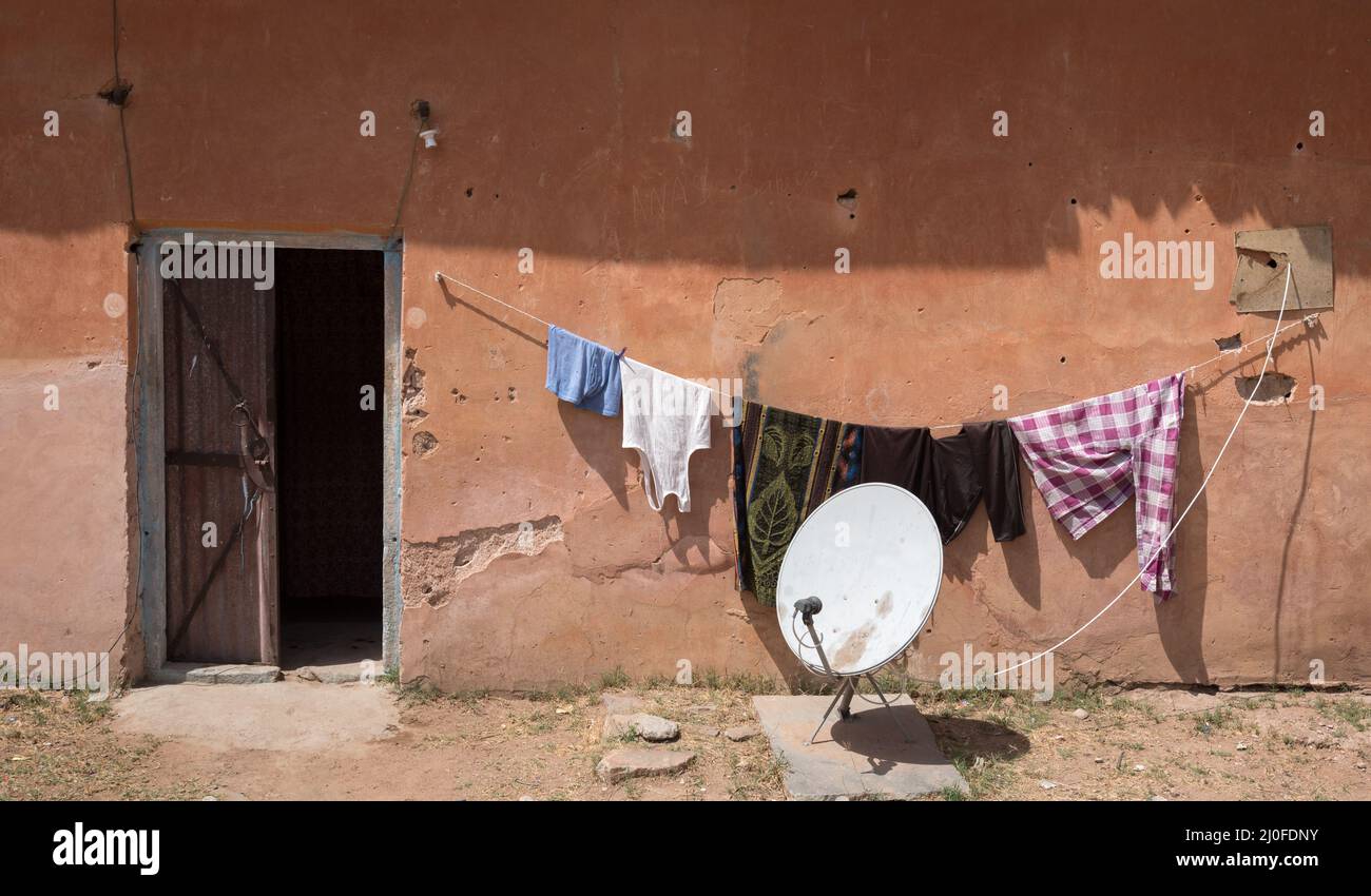 Exterior of a traditional Indian house with clothes hanging on the wire for drying Stock Photo