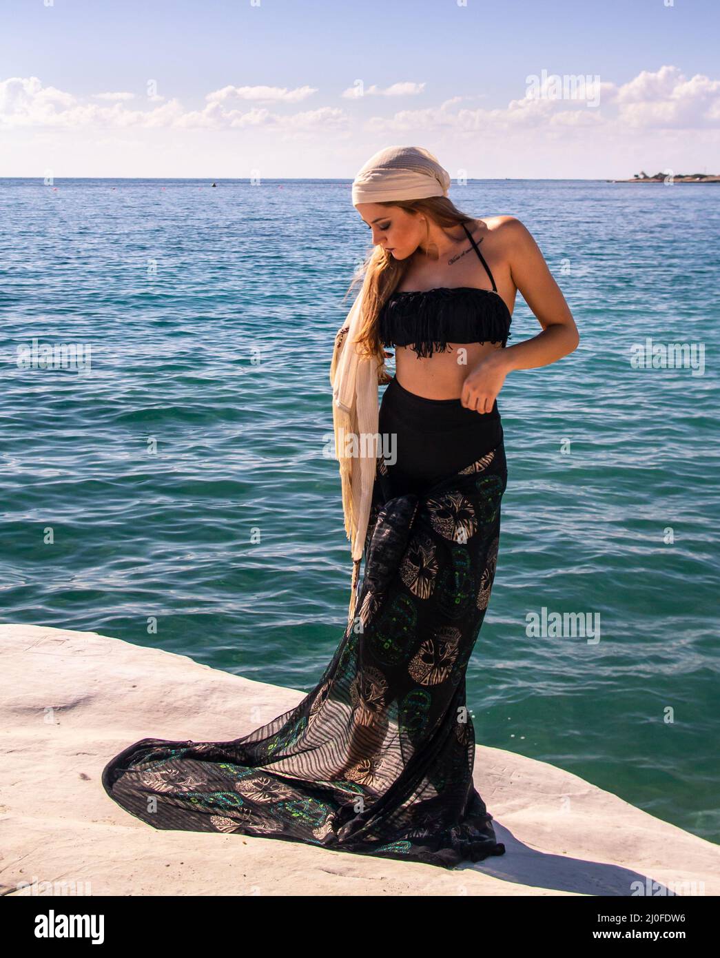 Young attractive on the beach with black summer clothes Stock Photo