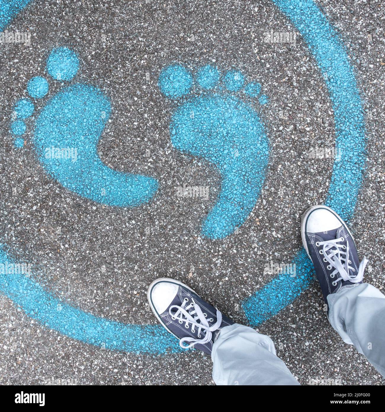Man standing on blue dot Stock Photo