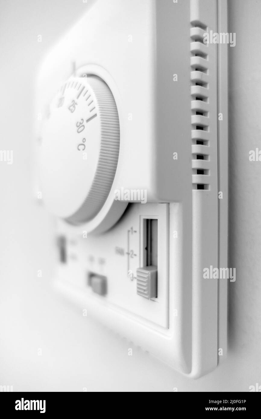 Hand adjusting thermostat Stock Photo Alamy