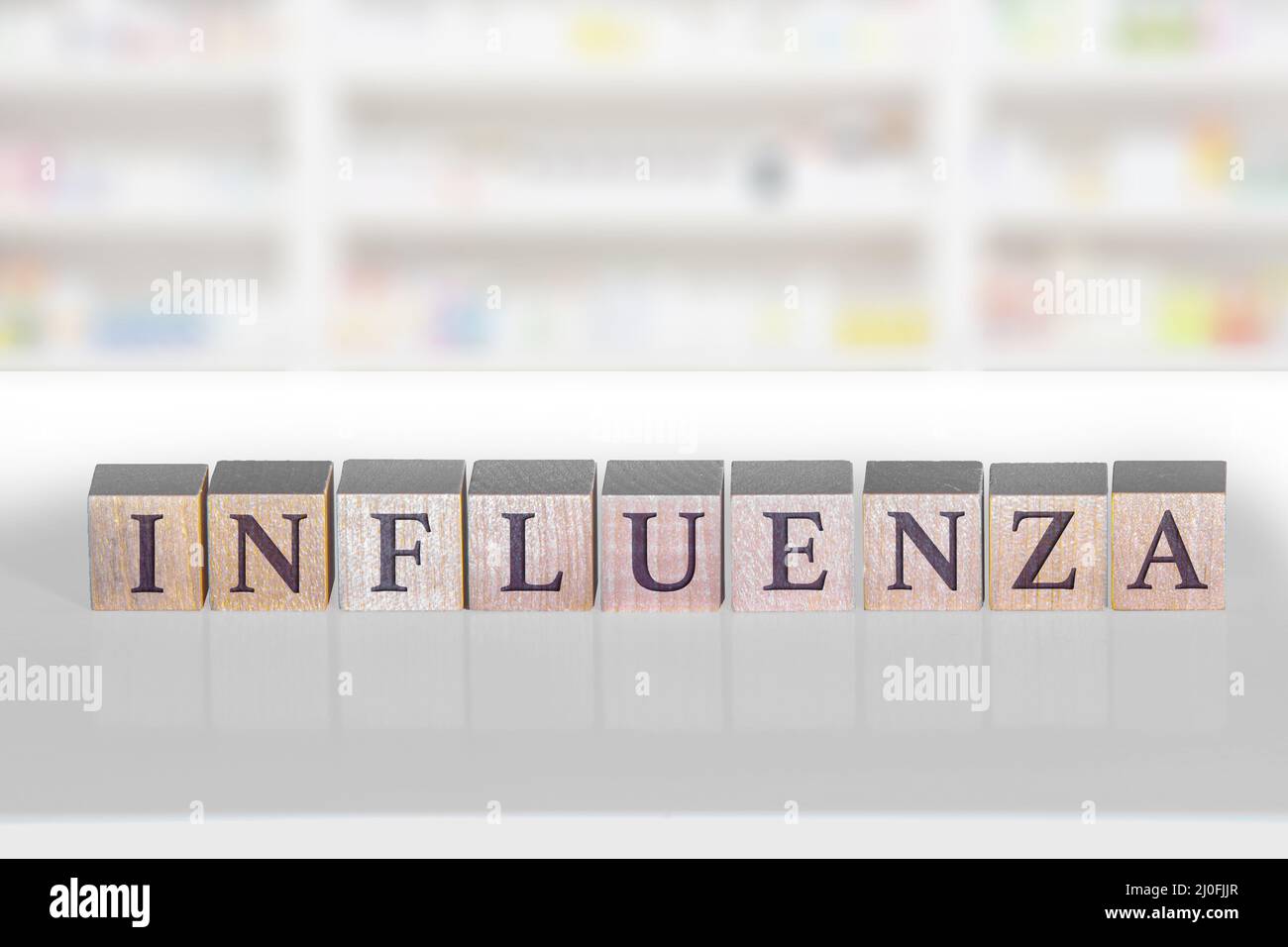 Wooden block with the word Influenza on a white background. Stock Photo